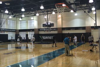 Inside the Hornets' redesigned practice court, with the table on the side where Jordan observes the team.