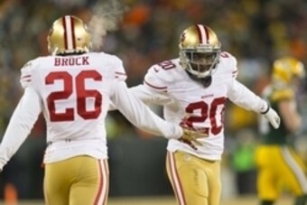 Jan 5, 2014; Green Bay, WI, USA; San Francisco 49ers cornerback Perrish Cox (20) celebrates with cornerback Tramaine Brock (26) following a play during the fourth quarter against the Green Bay Packers during the 2013 NFC wild card playoff football game at