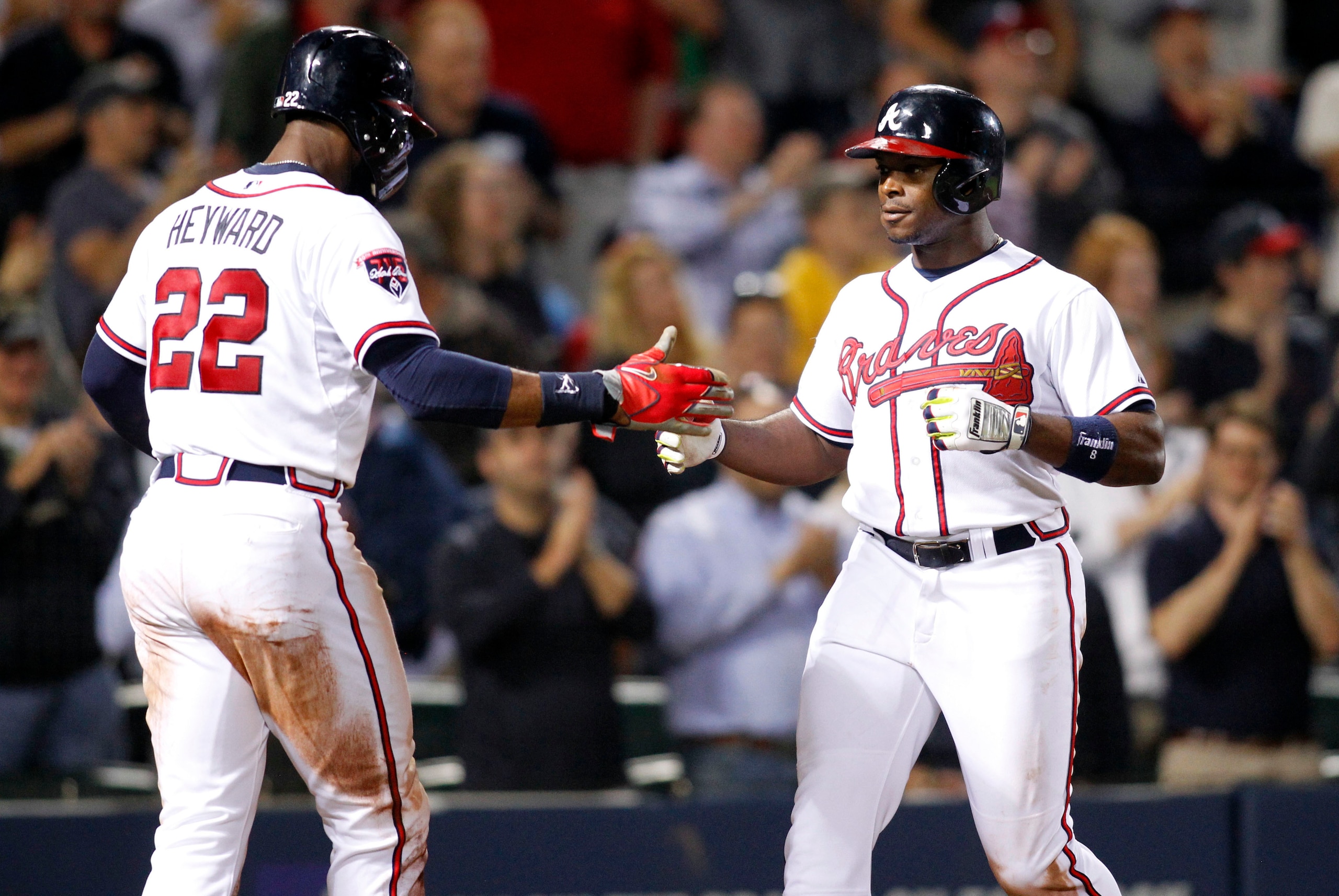 May 19, 2014; Atlanta, GA, USA; Atlanta Braves left fielder Justin Upton (8) celebrates a home run with right fielder Jason Heyward (22) against the Milwaukee Brewers in the eighth inning at Turner Field. The Braves defeated the Brewers 9-3. Mandatory Cre
