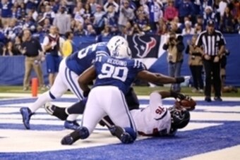 Dec 15, 2013; Indianapolis, IN, USA; Indianapolis Colts defensive end Cory Redding (90) tackles Houston Texans tackle Duane Brown (76) resulting in a safety at Lucas Oil Stadium. Indianapolis defeats Houston 25-3. Mandatory Credit: Brian Spurlock-USA TODA