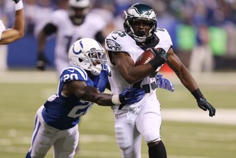 Sep 15, 2014; Indianapolis, IN, USA; Philadelphia Eagles running back LeSean McCoy (25) is tackled by Indianapolis Colts cornerback Darius Butler (20) at Lucas Oil Stadium. Mandatory Credit: Brian Spurlock-USA TODAY Sports