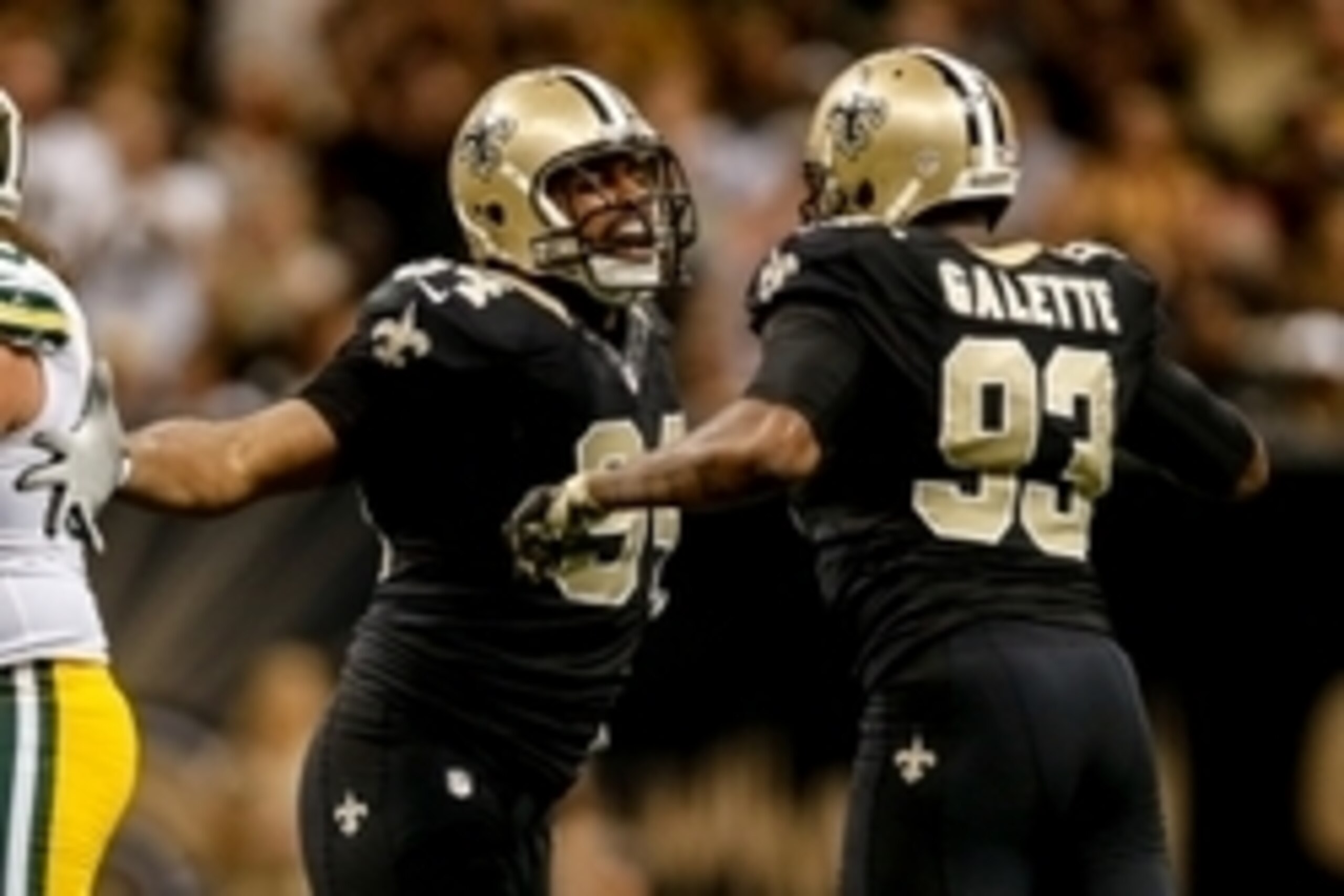Oct 26, 2014; New Orleans, LA, USA; New Orleans Saints defensive end Cameron Jordan (94) and outside linebacker Junior Galette (93) celebrate a sack during the second half of a game against the Green Bay Packers at the Mercedes-Benz Superdome. The Saints 