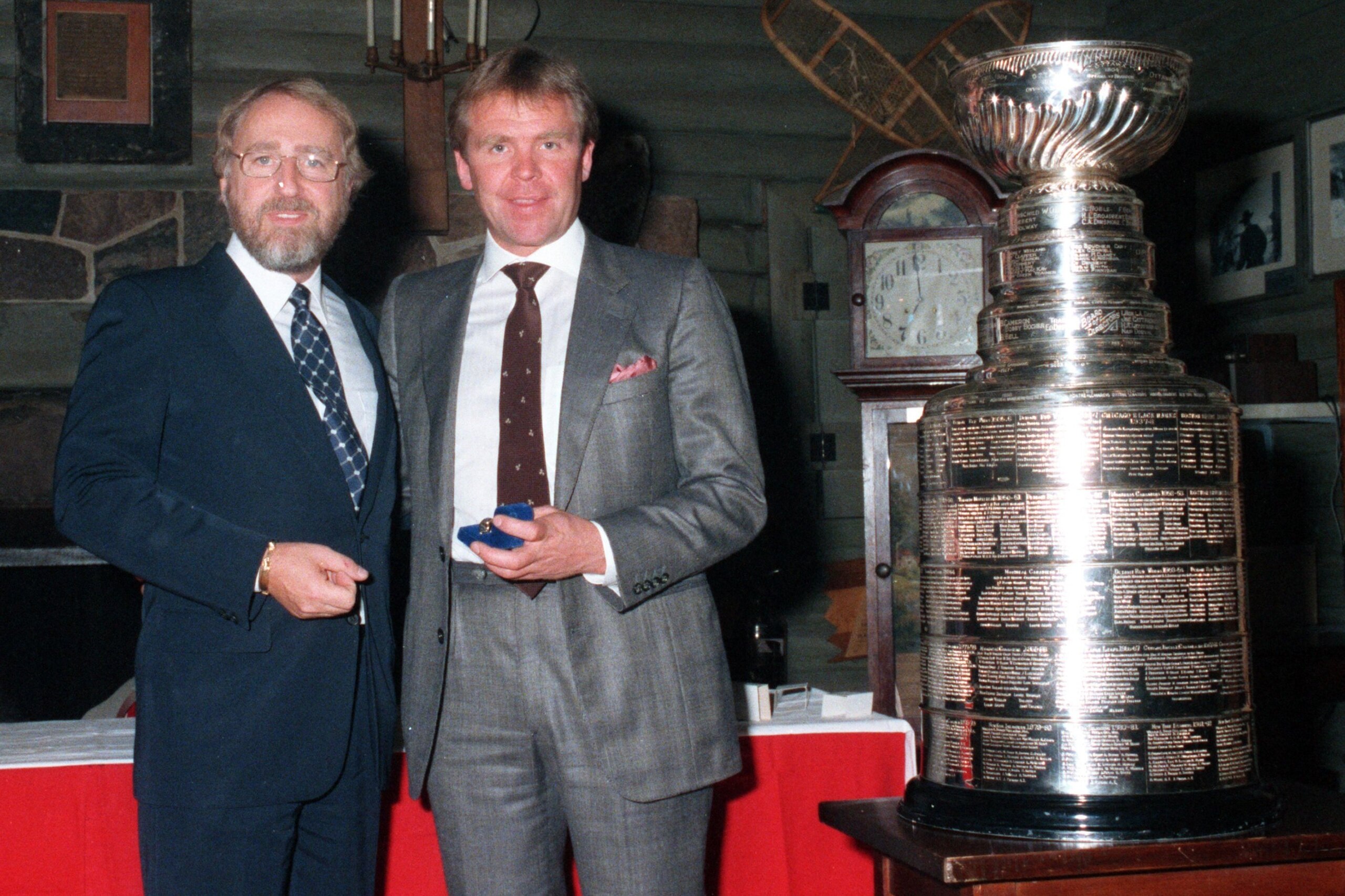 EDMONTON, CANADA - CIRCA 1984-85:  (L-R) Owner Peter Pocklington and Head Coach Glen Sather of the Edmonton Oilers pose for a photo next to the Stanley Cup circa 1984-85 in Edmonton, Alberta, Canada. (Photo by Andy Devling/NHLI via Getty Images)