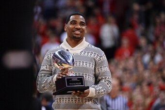 COLUMBUS, OH - FEBRUARY 19:  Braxton Miller #5 of the Ohio State Buckeyes football team shows off his second consecutive Chicago Tribune Silver Football presented to him in the first half of the basketball game between Ohio State and the Northwestern Wild