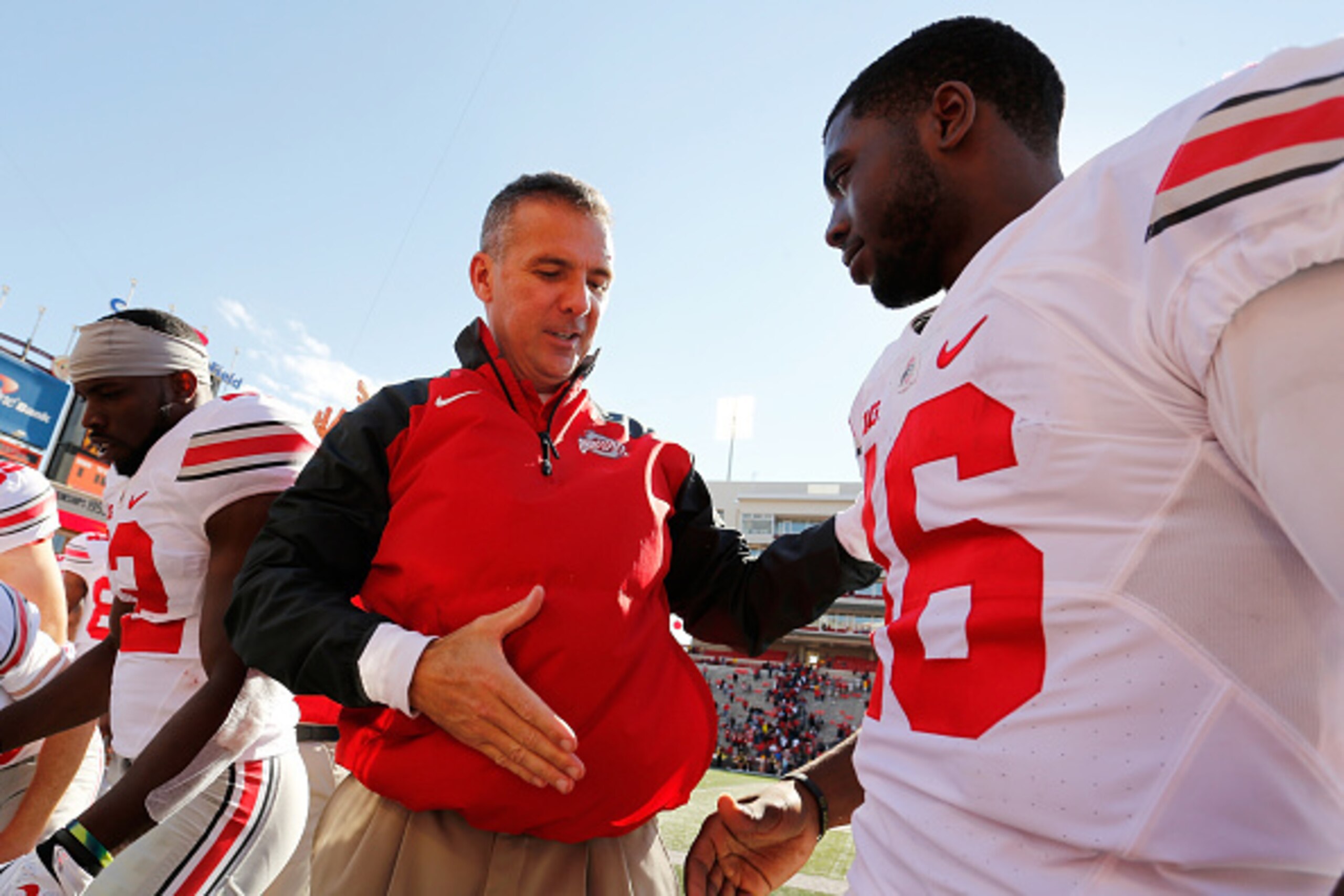 COLLEGE PARK, MD - OCTOBER 04:  Head coach Urban Meyer of the Ohio State Buckeyes (L) shakes hands with quarterback J.T. Barrett #16 (R) after their 52-24 win over the Maryland Terrapins at Byrd Stadium on October 4, 2014 in College Park, Maryland.  (Phot