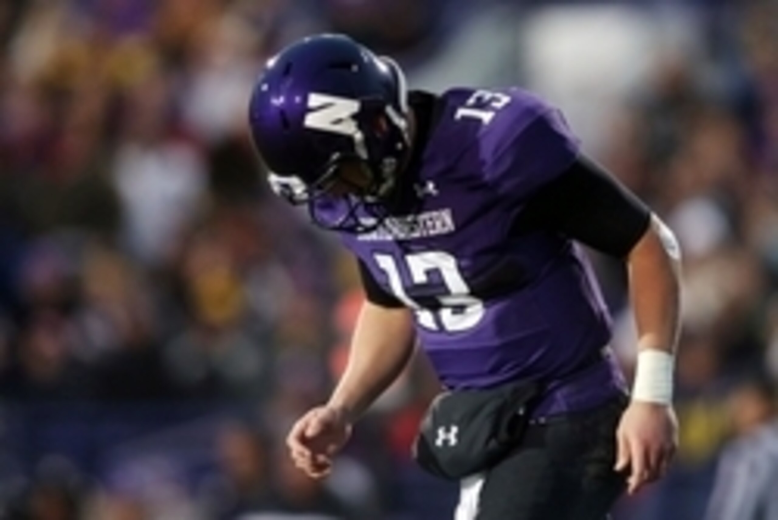 Nov 8, 2014; Evanston, IL, USA; Northwestern Wildcats quarterback Trevor Siemian (13) comes off the field after a failed third down conversion against the Michigan Wolverines in the second half at Ryan Field. Mandatory Credit: Jerry Lai-USA TODAY Sports