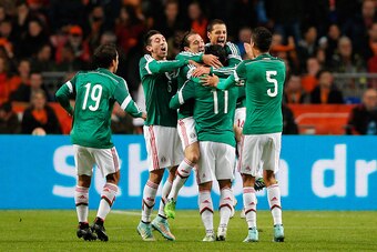 AMSTERDAM, NETHERLANDS - NOVEMBER 12:  Carlos Vela #11 of Mexico is congratulated by team mates after scoring the first goal of the game during the international friendly match between Netherlands and Mexico held at the Amsterdam ArenA on November 12, 201