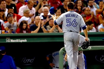 BOSTON, MA - JULY 30: Mark Buehrle #56 of the Toronto Blue Jays tips his cap to fans as he leaves the game in the seventh inning against the Boston Red Sox at Fenway Park on July 30, 2014 in Boston, Massachusetts.  (Photo by Jim Rogash/Getty Images)