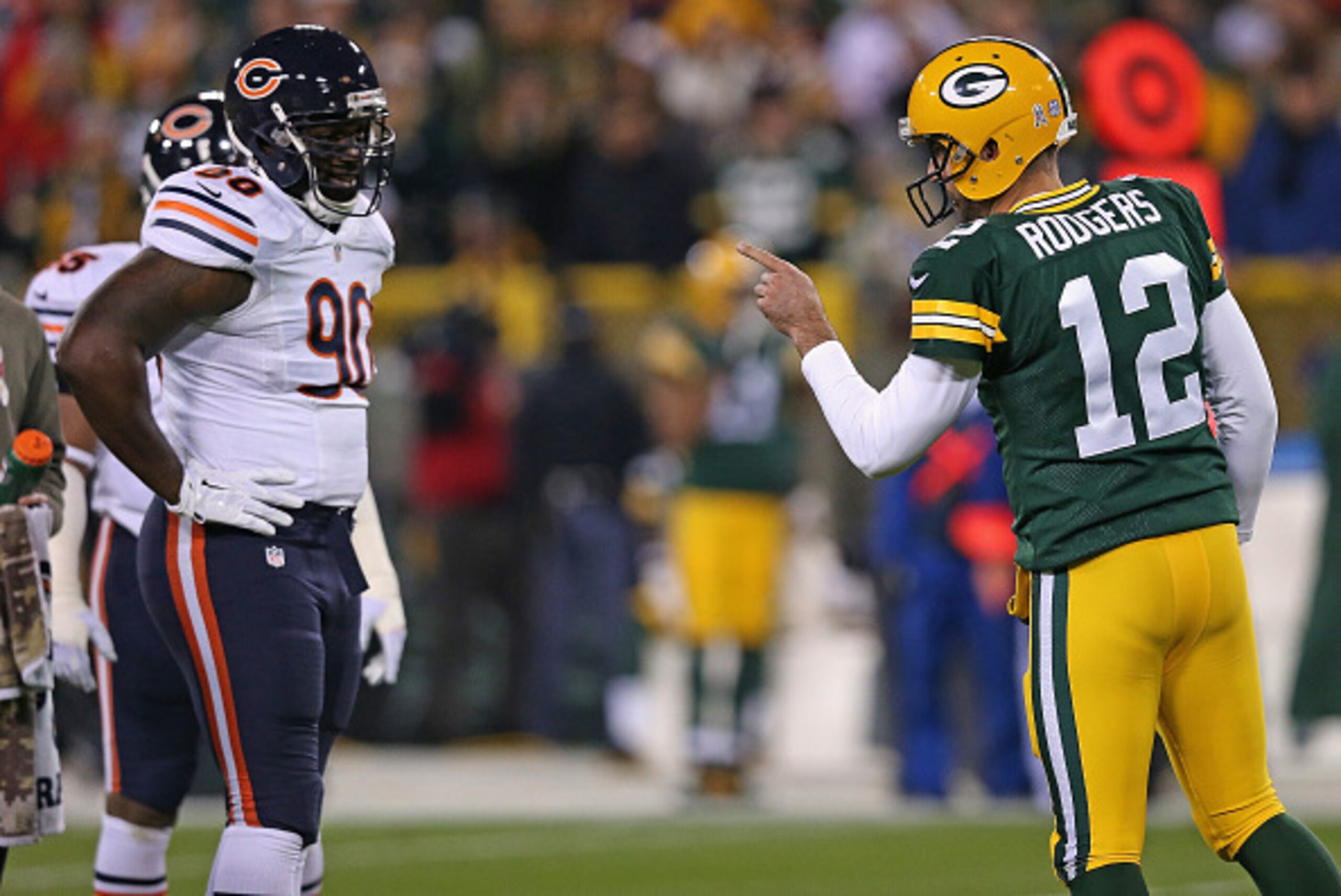 GREEN BAY, WI - NOVEMBER 09: Quarterback Aaron Rodgers #12 of the Green Bay Packers talks with the Chicago Bears defense, including  Jeremiah Ratliff #90, in the first half of the game at Lambeau Field on November 9, 2014 in Green Bay, Wisconsin. (Photo b