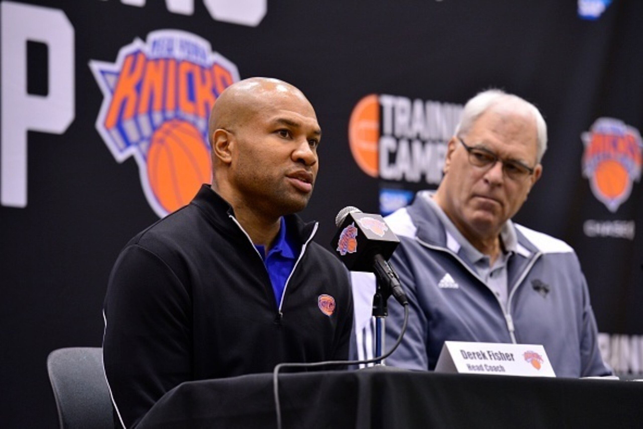 TARRYTOWN, NY - SEPTEMBER 26: New York Knicks Head Coach Derek Fisher and Phil Jackson talk to the media during a press conference on September 26, 2014 in Tarrytown, New York. NOTE TO USER: User expressly acknowledges and agrees that, by downloading and/