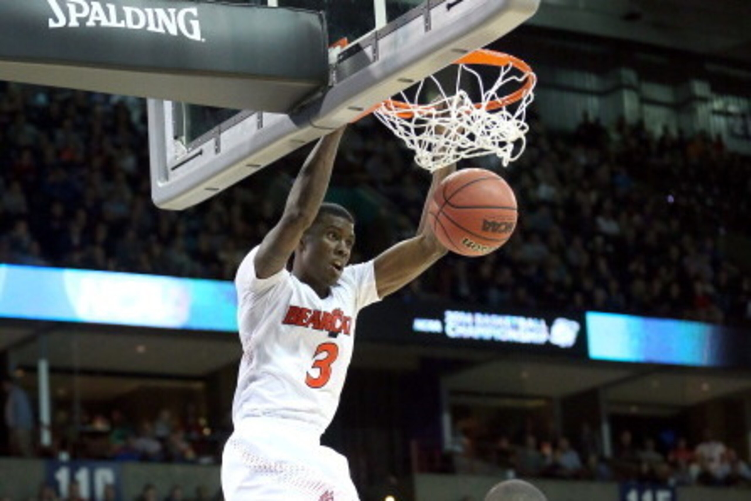 SPOKANE, WA - MARCH 20:  Shaquille Thomas #3 of the Cincinnati Bearcats dunks over Siyani Chambers #1 of the Harvard Crimson during the second round of the 2014 NCAA Men's Basketball Tournament at Spokane Veterans Memorial Arena on March 20, 2014 in Spoka