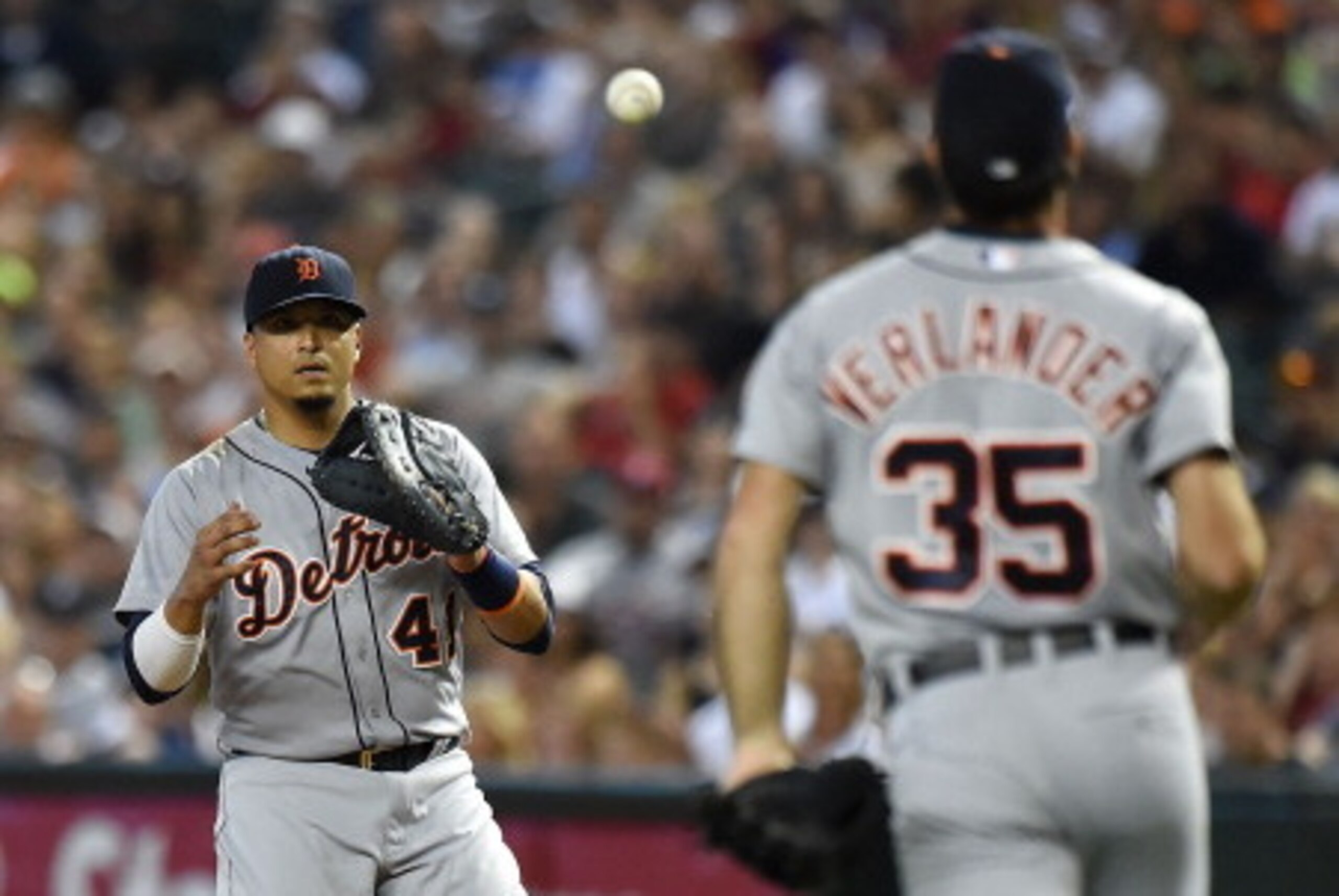 PHOENIX, AZ - JULY 21:  Pitcher Justin Verlander #35 of the Detroit Tigers underhands the ball to Victor Martinez #41 at first base during the first inning against the Arizona Diamondbacks at Chase Field on July 21, 2014 in Phoenix, Arizona.  (Photo by No