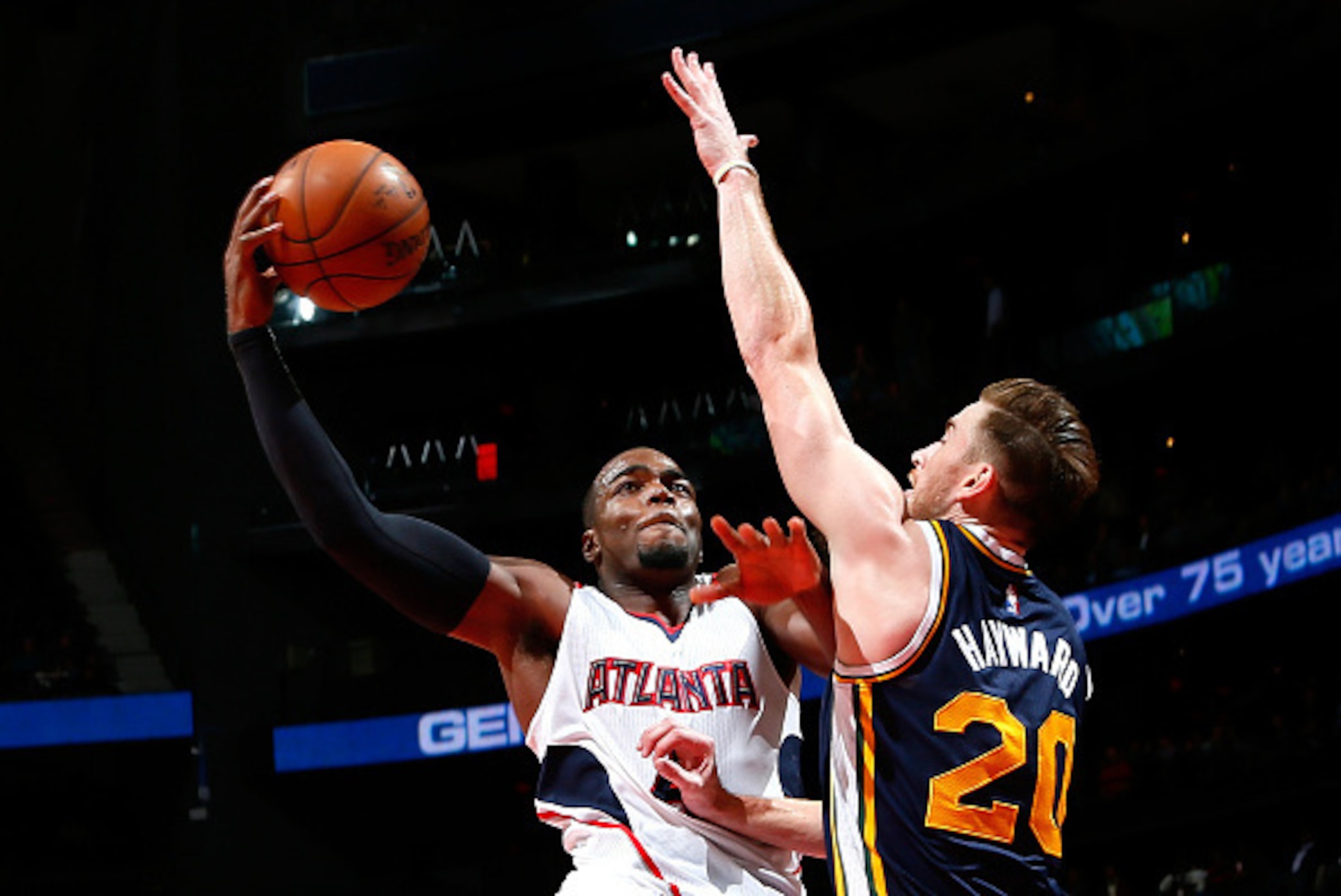 ATLANTA, GA - NOVEMBER 12:  Paul Millsap #4 of the Atlanta Hawks drives against Gordon Hayward #20 of the Utah Jazz at Philips Arena on November 12, 2014 in Atlanta, Georgia.  NOTE TO USER: User expressly acknowledges and agrees that, by downloading and o