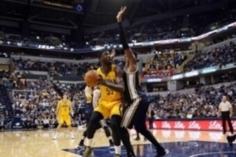 Nov 10, 2014; Indianapolis, IN, USA; Indiana Pacers center Roy Hibbert (55) takes a shot against Utah Jazz forward Derrick Favors (15) at Bankers Life Fieldhouse. Indiana defeats Utah 97-86. Mandatory Credit: Brian Spurlock-USA TODAY Sports