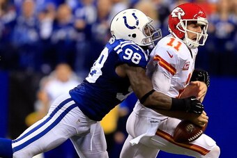 INDIANAPOLIS, IN - JANUARY 04:  Outside linebacker Robert Mathis #98 of the Indianapolis Colts forces a fumble by quarterback Alex Smith #11 of the Kansas City Chiefs during a Wild Card Playoff game at Lucas Oil Stadium on January 4, 2014 in Indianapolis,