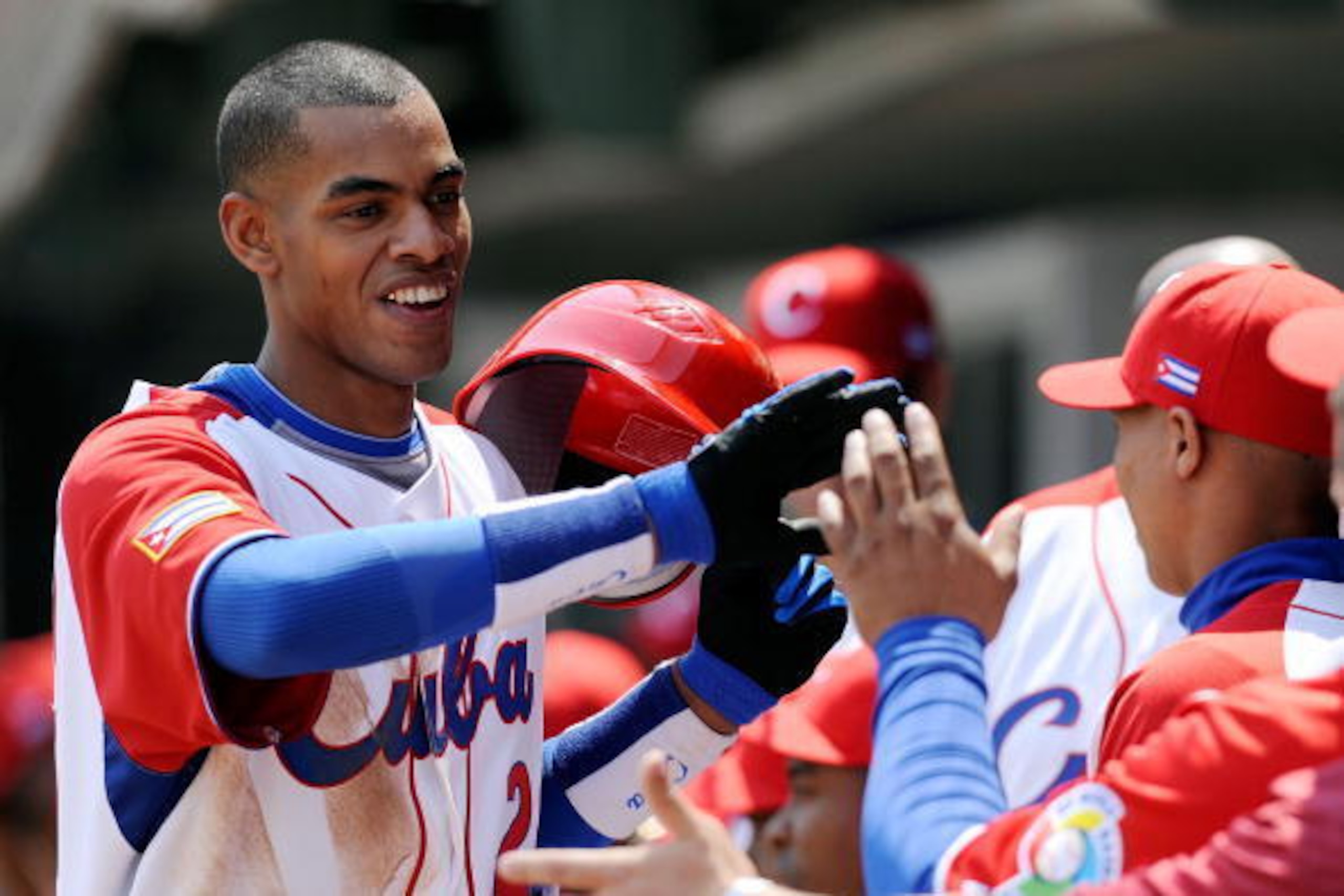 MEXICO CITY - MARCH 08:  Hector Olivera #28 of Cuba is congratulated by his teammates after hitting a home run against South Africa during the 2009 World Baseball Classic Pool B match on March 8, 2009 at the Estadio Foro Sol in Mexico City, Mexico.  (Phot