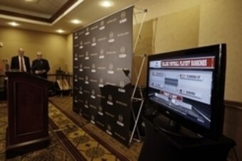 Oct 28, 2014; Grapevine, TX, USA;  Executive director Bill Hancock (far left) watches as ESPN unveils the first top 25 college football playoff rankings at the Gaylord Texan Hotel. Mandatory Credit: Kevin Jairaj-USA TODAY Sports