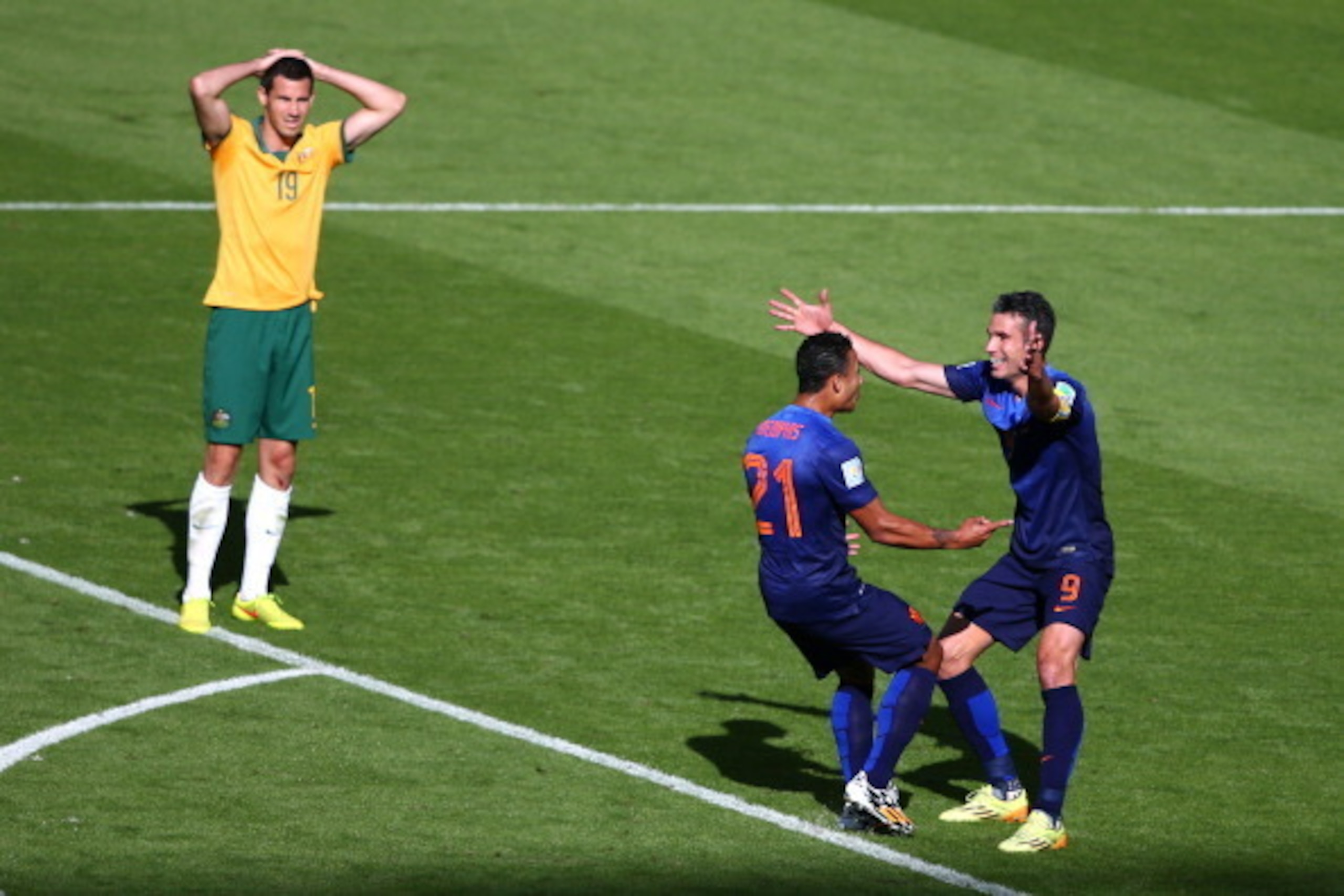 PORTO ALEGRE, BRAZIL - JUNE 18: Memphis Depay of the Netherlands celebrates scoring his team's third goal with Robin van Persie as Ryan McGowan of Australia looks on during the 2014 FIFA World Cup Brazil Group B match between Australia and Netherlands at 