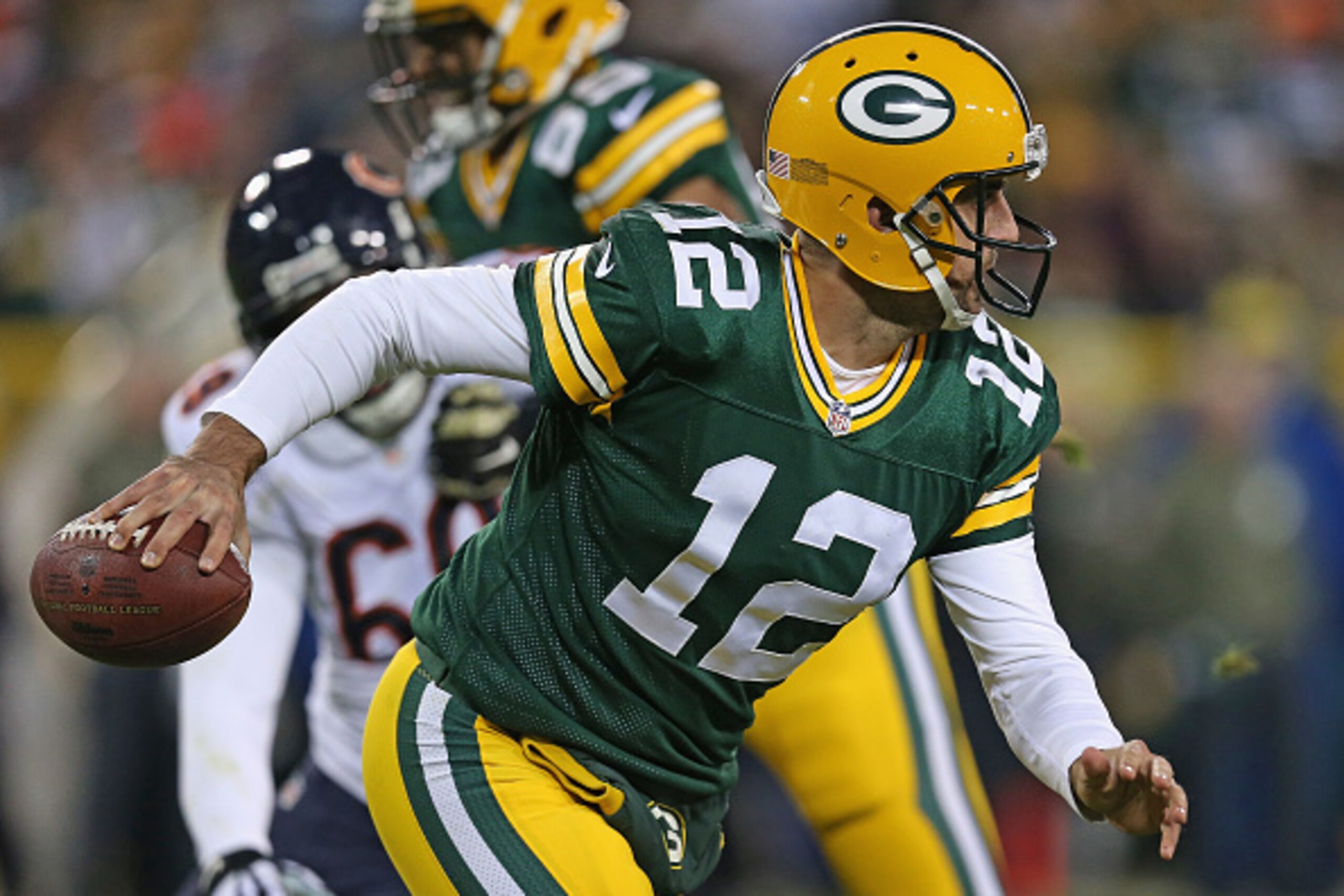 GREEN BAY, WI - NOVEMBER 09: Quarterback  Aaron Rodgers #12 of the Green Bay Packers carries the football in the second quarter against the Chicago Bears at Lambeau Field on November 9, 2014 in Green Bay, Wisconsin. (Photo by Jonathan Daniel/Getty Images)