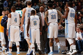 DENVER, CO - NOVEMBER 03:  Head coach Brian Shaw (center) of the Denver Nuggets brings Randy Foye #4, Timofey Mozgov #25, Nate Robinson #5, Wilson Chandler #21 and Darrell Arthur #00 of the Denver Nuggets to the bench for a time out against the Sacramento