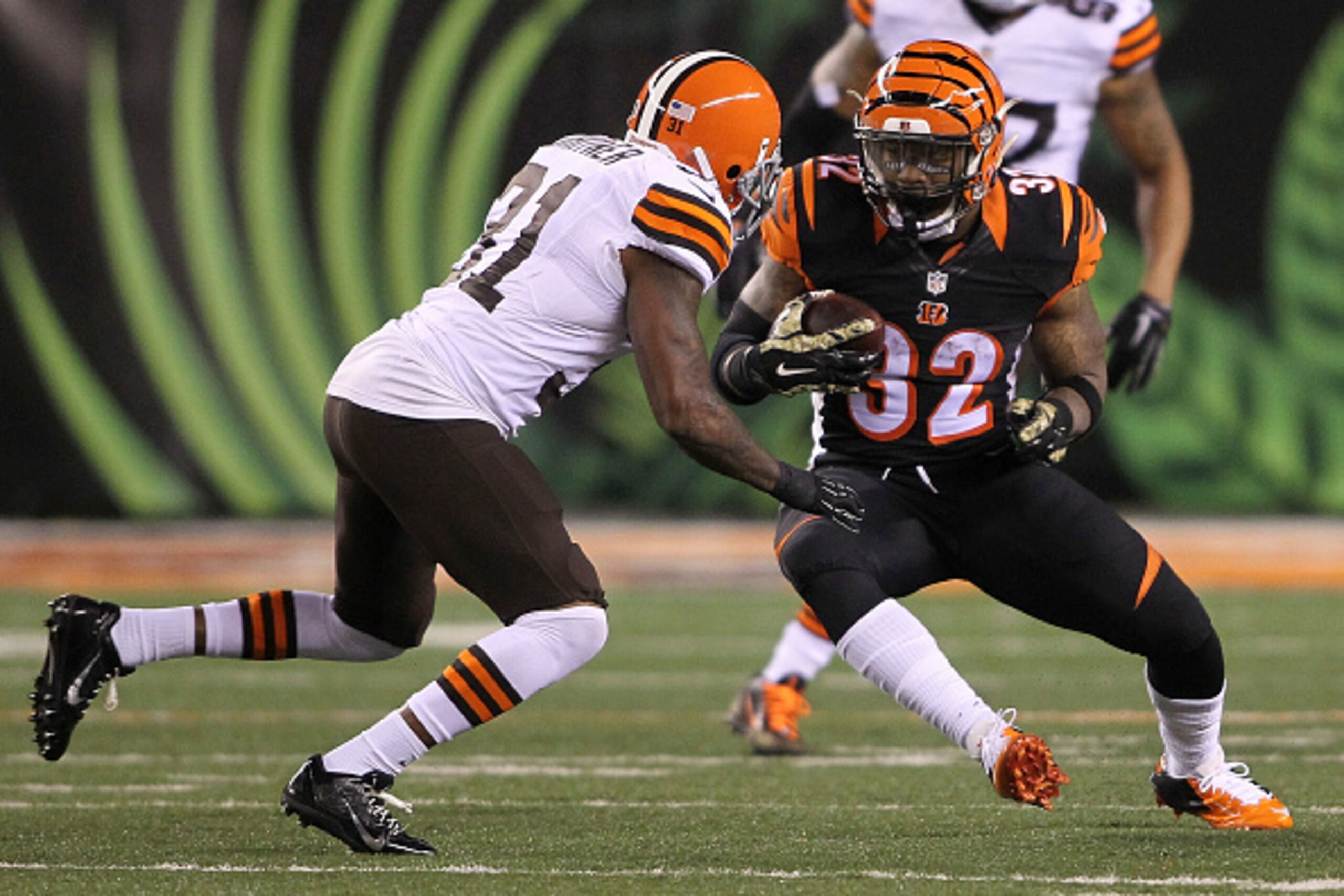 CINCINNATI, OH - NOVEMBER 6:  Jeremy Hill #32 of the Cincinnati Bengals attempts to run past Donte Whitner #31 of the Cleveland Browns during the first quarter at Paul Brown Stadium on November 6, 2014 in Cincinnati, Ohio. (Photo by John Grieshop/Getty Im