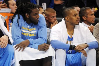Nov 1, 2014; Oklahoma City, OK, USA;  Denver Nuggets forward Kenneth Faried (35) and guard Randy Foye (4) watch their team from the bench in action against the Oklahoma City Thunder during the fourth quarter at Chesapeake Energy Arena. Mandatory Credit: M