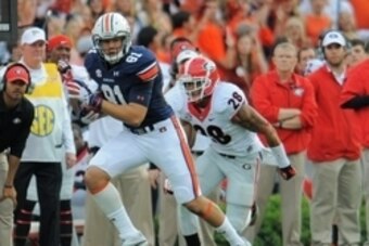 Nov 16, 2013; Auburn, AL, USA; Auburn Tigers tight end C.J. Uzomah (81) runs the ball ahead of Georgia Bulldogs safety Tray Matthews (28) during the first half at Jordan Hare Stadium. Mandatory Credit: Shanna Lockwood-USA TODAY Sports
