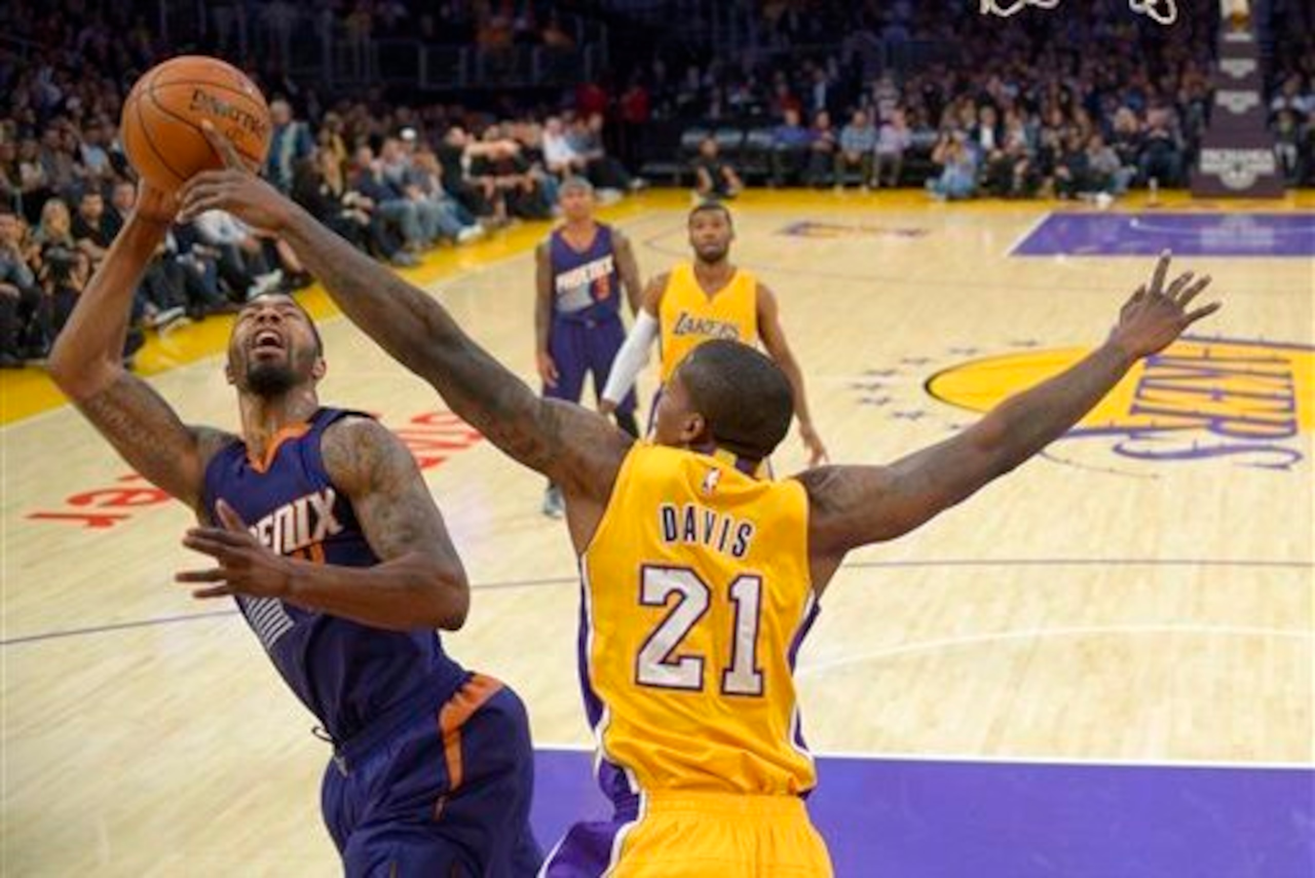 Davis blocks a layup attempt by Phoenix Suns forward Markieff Morris.