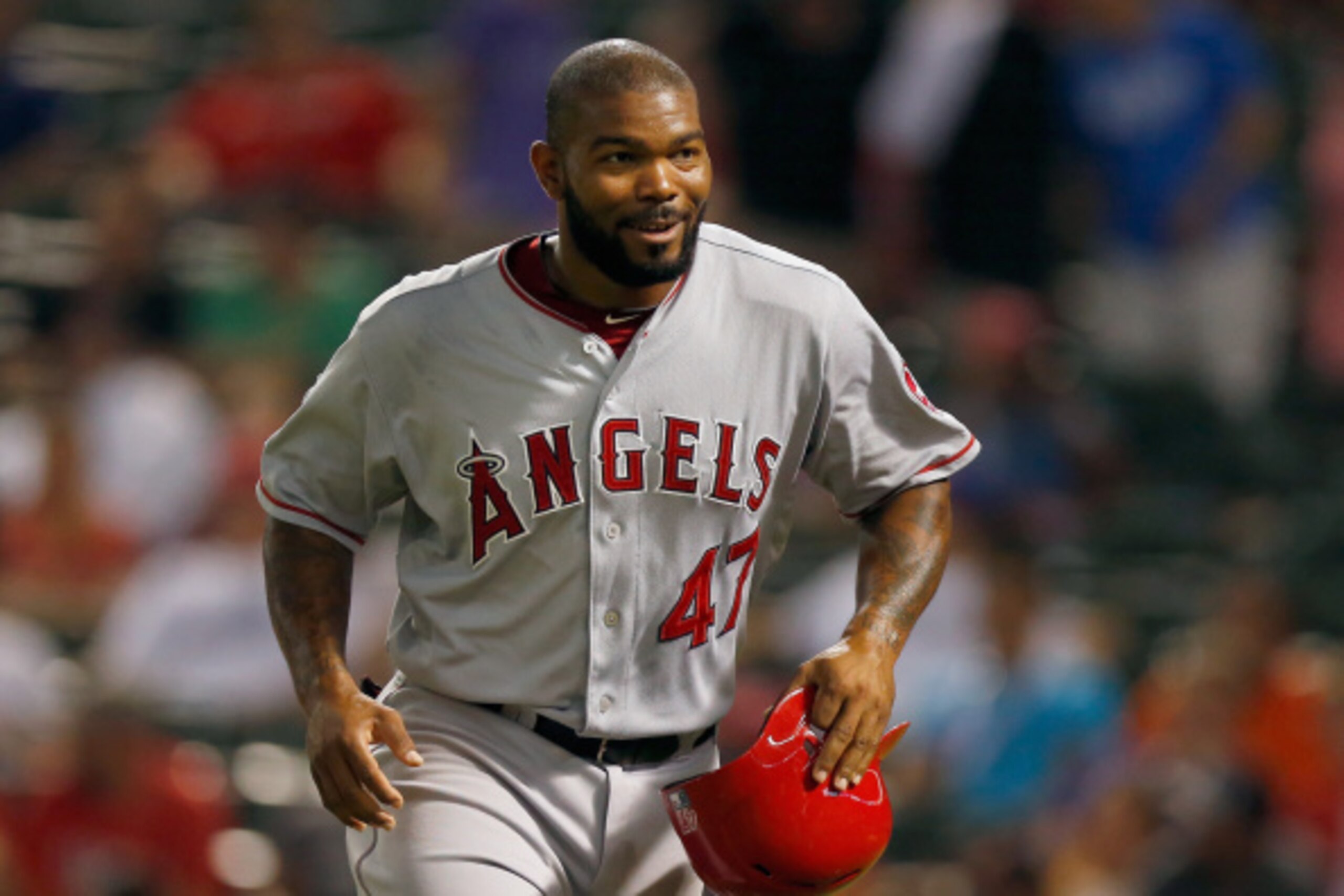 ARLINGTON, TX - SEPTEMBER 09:  Howie Kendrick #47 of the Los Angeles Angels celebrates after scoring against the Texas Rangers in the top of the eighth inning at Globe Life Park in Arlington on September 9, 2014 in Arlington, Texas.  (Photo by Tom Penning