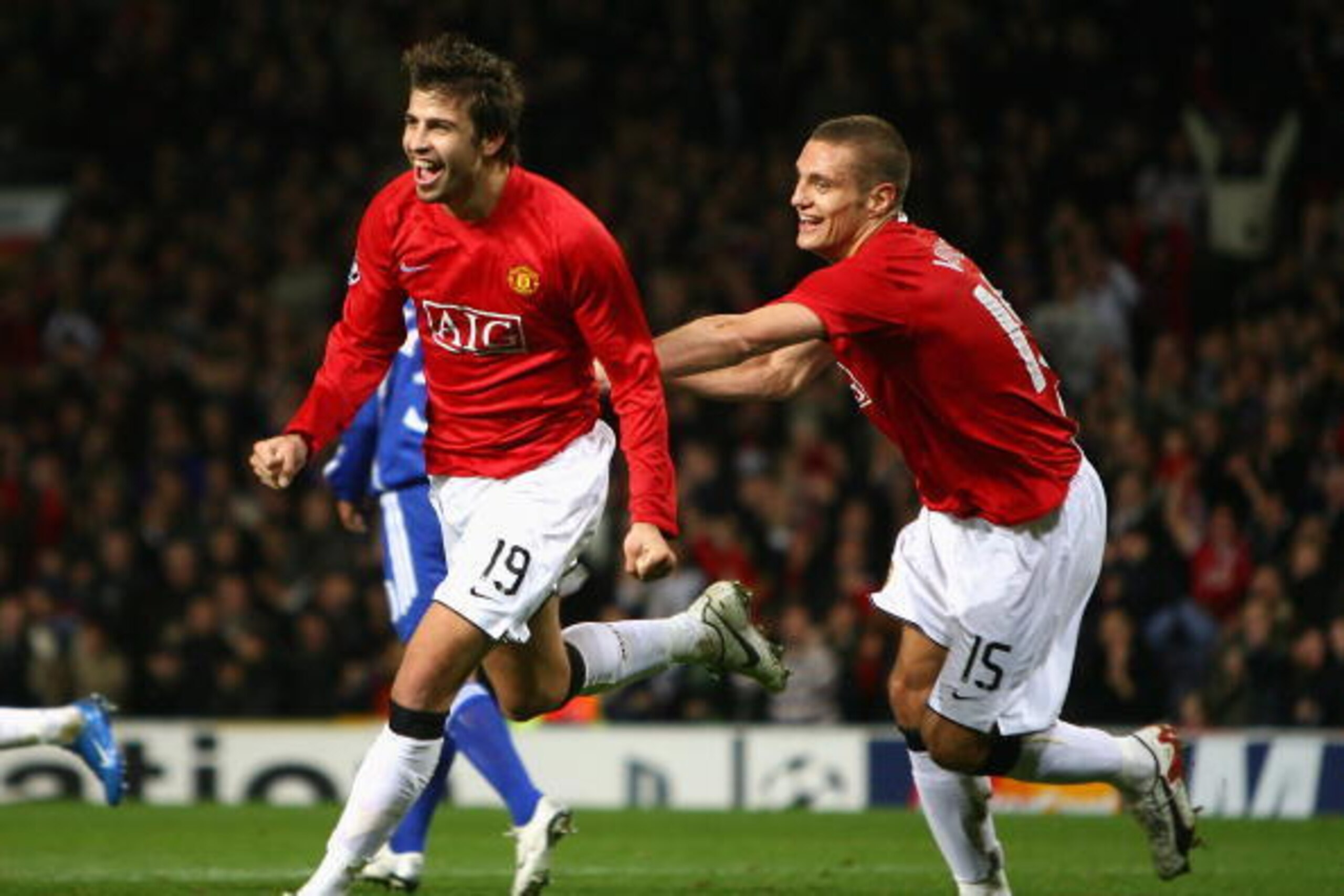 MANCHESTER, UNITED KINGDOM - NOVEMBER 07:  Gerard Pique of Manchester United celebrates scoring the opening goal with team mate Nemanja Vidic (R) during the UEFA Champions League Group F match between Manchester United and Dynamo Kyiv at Old Trafford on N
