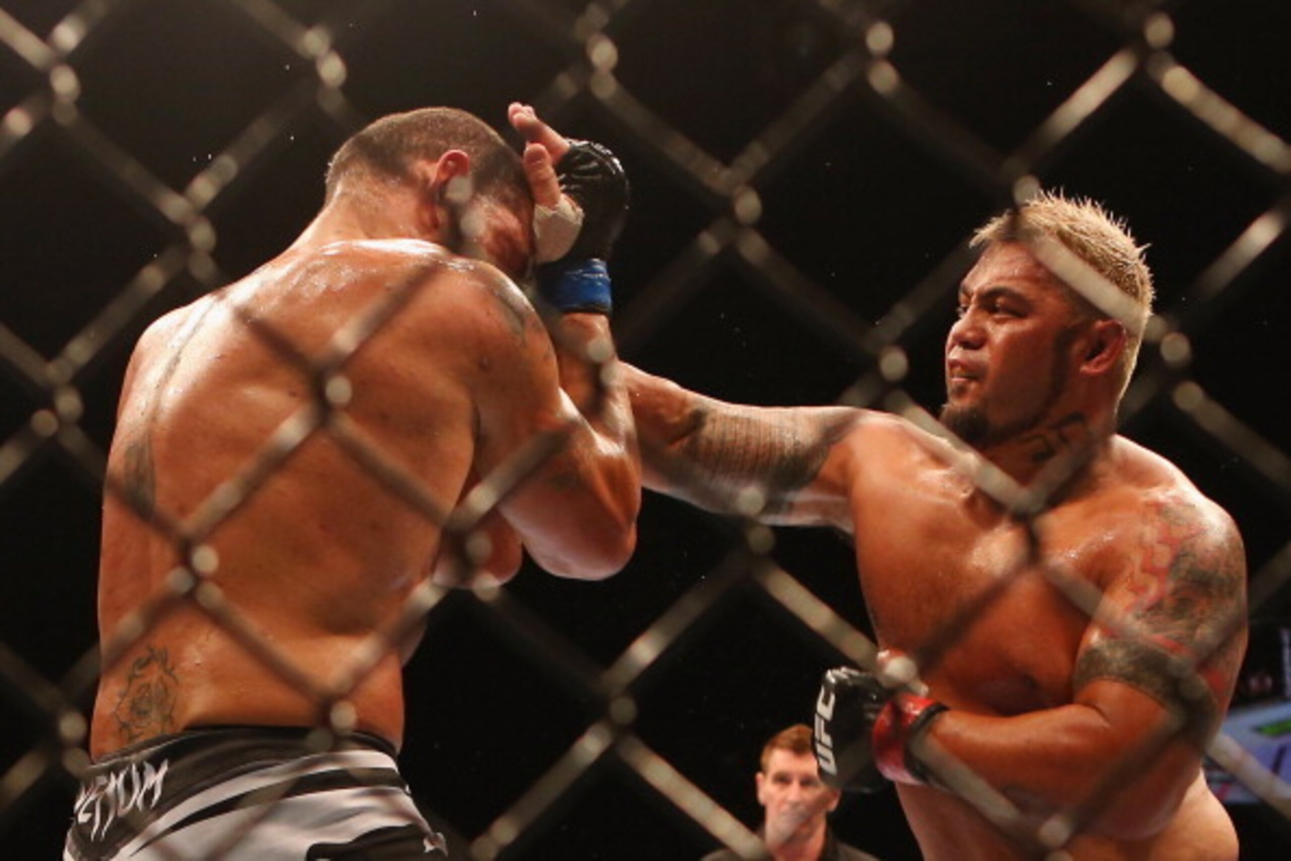 BRISBANE, AUSTRALIA - DECEMBER 07:  Mark Hunt punches Antonio 'Big Foot' Silva of Brazil during the UFC Brisbane bout between Mark Hunt and Antonio 'Big Foot' Silva of Brazil at Brisbane Entertainment Centre on December 7, 2013 in Brisbane, Australia.  (P