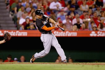 ANAHEIM, CA - AUGUST 25:  Giancarlo Stanton #27 of the Miami Marlins hits a three-run home run against the Los Angeles Angels of Anaheim in the fourth inning at Angel Stadium of Anaheim on August 25, 2014 in Anaheim, California.  (Photo by Jeff Gross/Gett