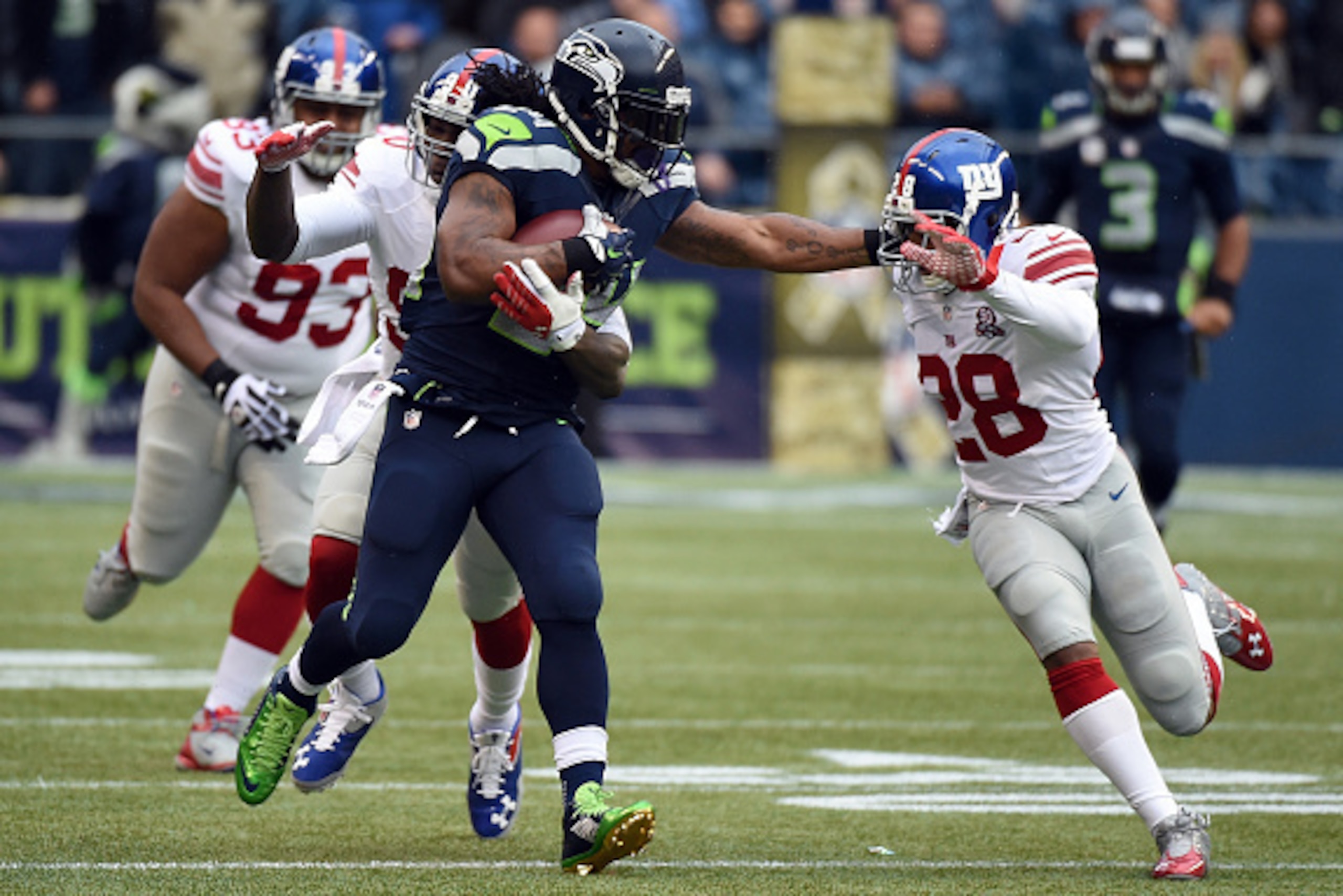 SEATTLE, WA - NOVEMBER 09: Running back Marshawn Lynch #24 of the Seattle Seahawks gives cornerback Jayron Hosley #28 of the New York Giants a stiff arm during the first quarter of the game at CenturyLink Field on November 9, 2014 in Seattle, Washington. SEATTLE, WA - NOVEMBER 09: Running back Marshawn Lynch #24 of the Seattle Seahawks gives cornerback Jayron Hosley #28 of the New York Giants a stiff arm during the first quarter of the game at CenturyLink Field on November 9, 2014 in Seattle, Washington.