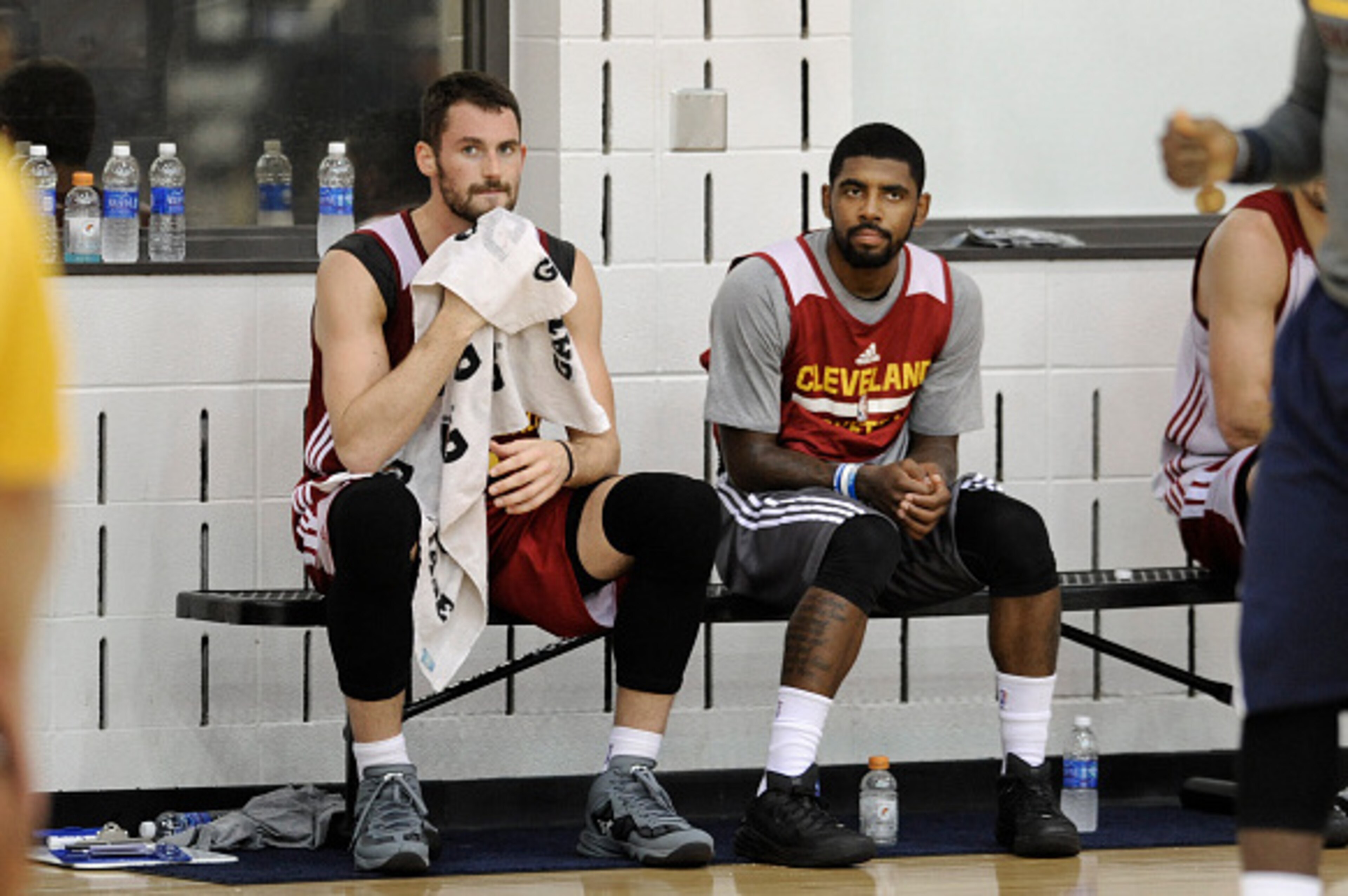 INDEPENDENCE, OH - SEPTEMBER 30: Kevin Love #0 and Kyrie Irving #2 of the Cleveland Cavaliers sit on the sideline during a practice at The Cleveland Clinic Courts on September 30, 2014 in Independence, Ohio. NOTE TO USER: User expressly acknowledges and a