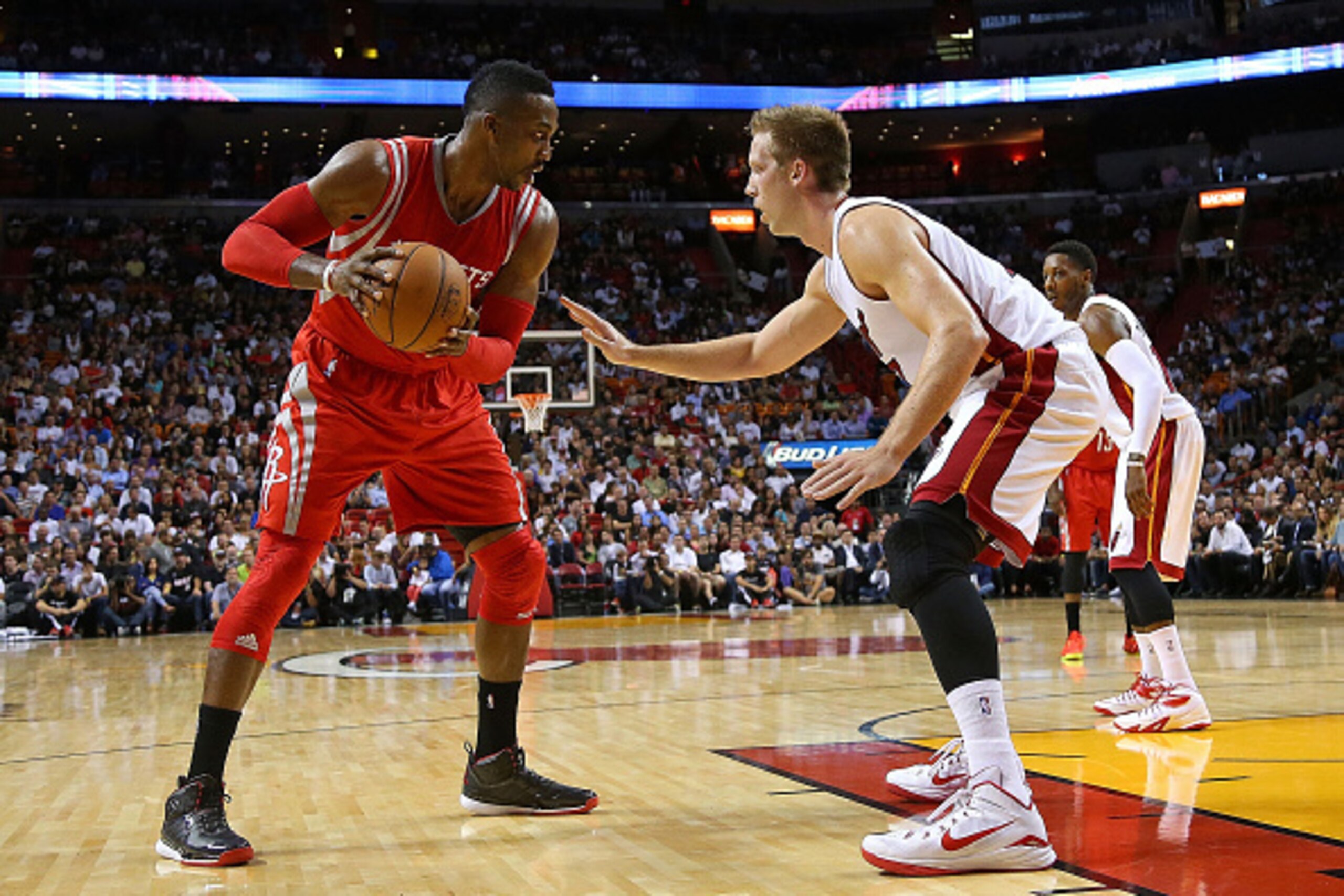 MIAMI, FL - NOVEMBER 04:  Dwight Howard #12 of the Houston Rockets drives on Justin Hamilton #7 of the Miami Heat during a game  at American Airlines Arena on November 4, 2014 in Miami, Florida. NOTE TO USER: User expressly acknowledges and agrees that, b