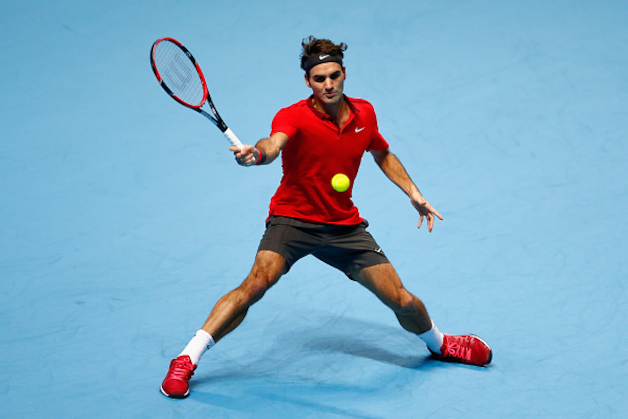 LONDON, ENGLAND - NOVEMBER 13:  Roger Federer of Switzerland plays a forehand in the round robin singles match against Andy Murray of Great Britain  on day five of the Barclays ATP World Tour Finals at O2 Arena on November 13, 2014 in London, England.  (P