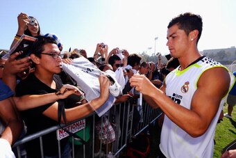 LOS ANGELES, CA - AUGUST 05: Cristiano Ronaldo #9 of Real Madrid signs a soccer shirt after participating in the Adidas training with local youth soccer player August 5, 2010 in Westwood section of Los Angeles, California.   (Photo by Kevork Djansezian/Ge