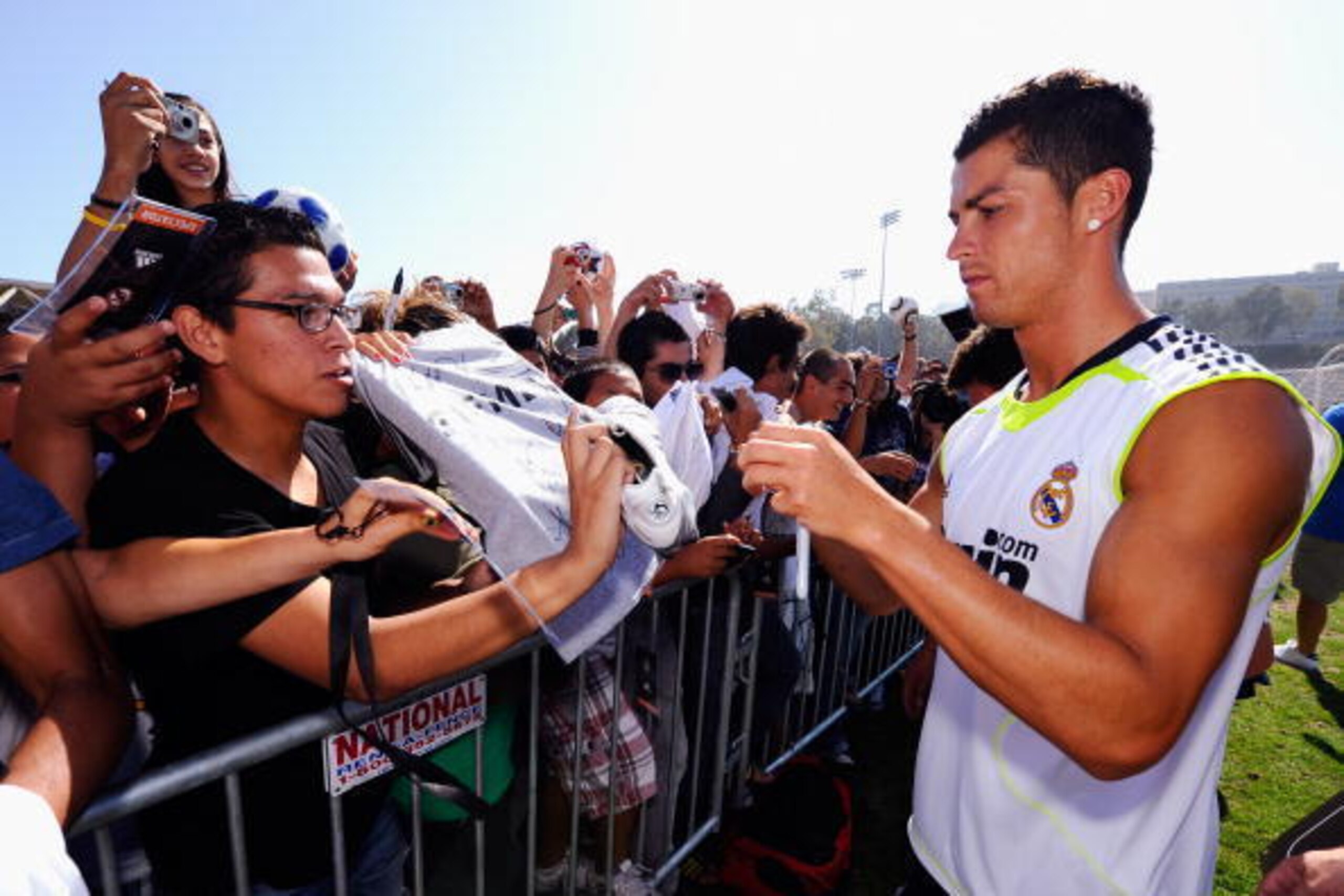 LOS ANGELES, CA - AUGUST 05: Cristiano Ronaldo #9 of Real Madrid signs a soccer shirt after participating in the Adidas training with local youth soccer player August 5, 2010 in Westwood section of Los Angeles, California.   (Photo by Kevork Djansezian/Ge