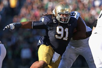 SOUTH BEND, IN - OCTOBER 11: Sheldon Day #91 of the Notre Dame Fighting Irish rushes past Landon Turner #78 of the North Carolina Tar Heels at Notre Dame Stadium on October 11, 2014 in South Bend, Indiana. (Photo by Jonathan Daniel/Getty Images)