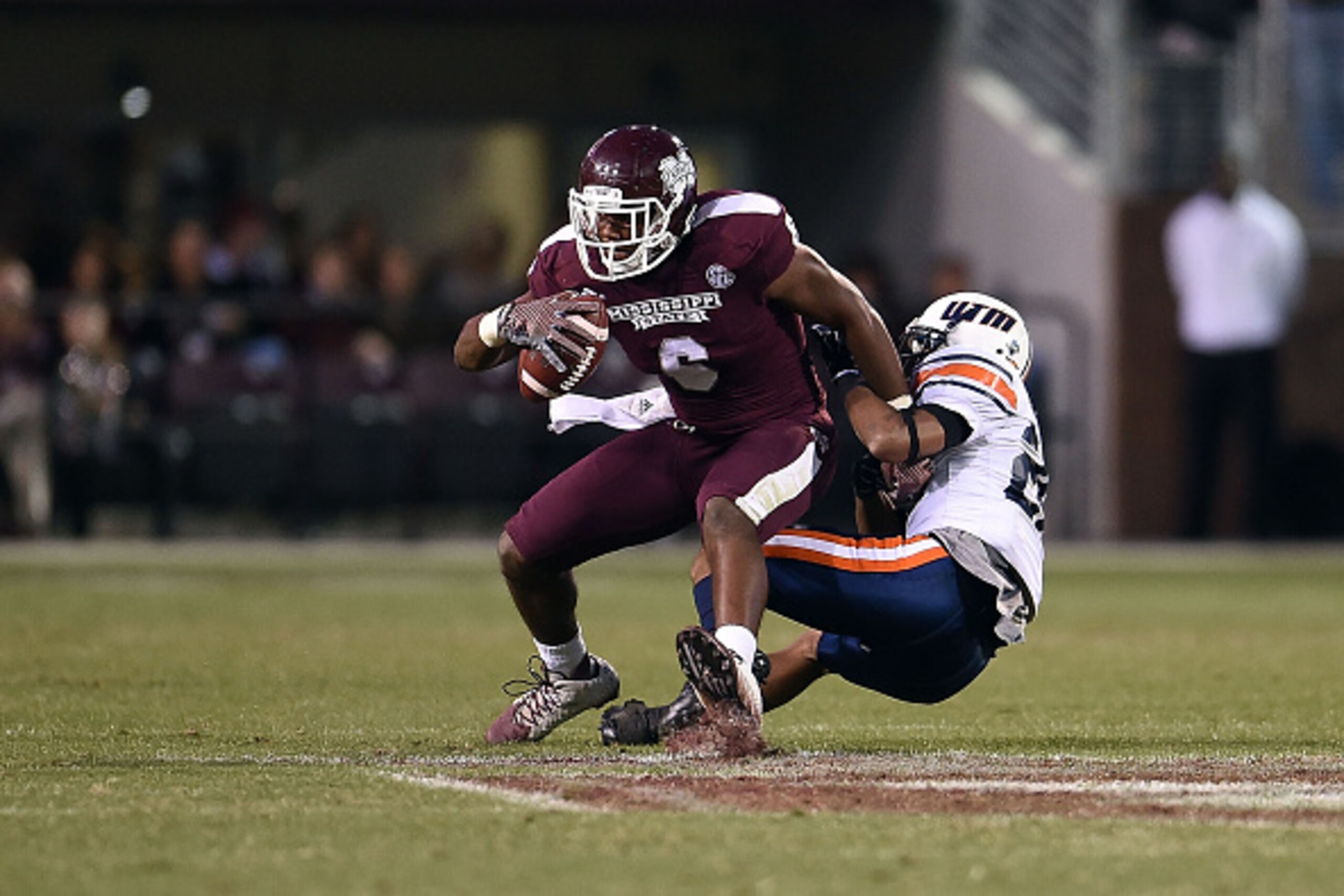 STARKVILLE, MS - NOVEMBER 08:  Malcolm Johnson #6 of the Mississippi State Bulldogs is brought down by Walter Evans #26 of the Tennessee Martin Skyhawks during the third quarter of a game at Davis Wade Stadium on November 8, 2014 in Starkville, Mississipp