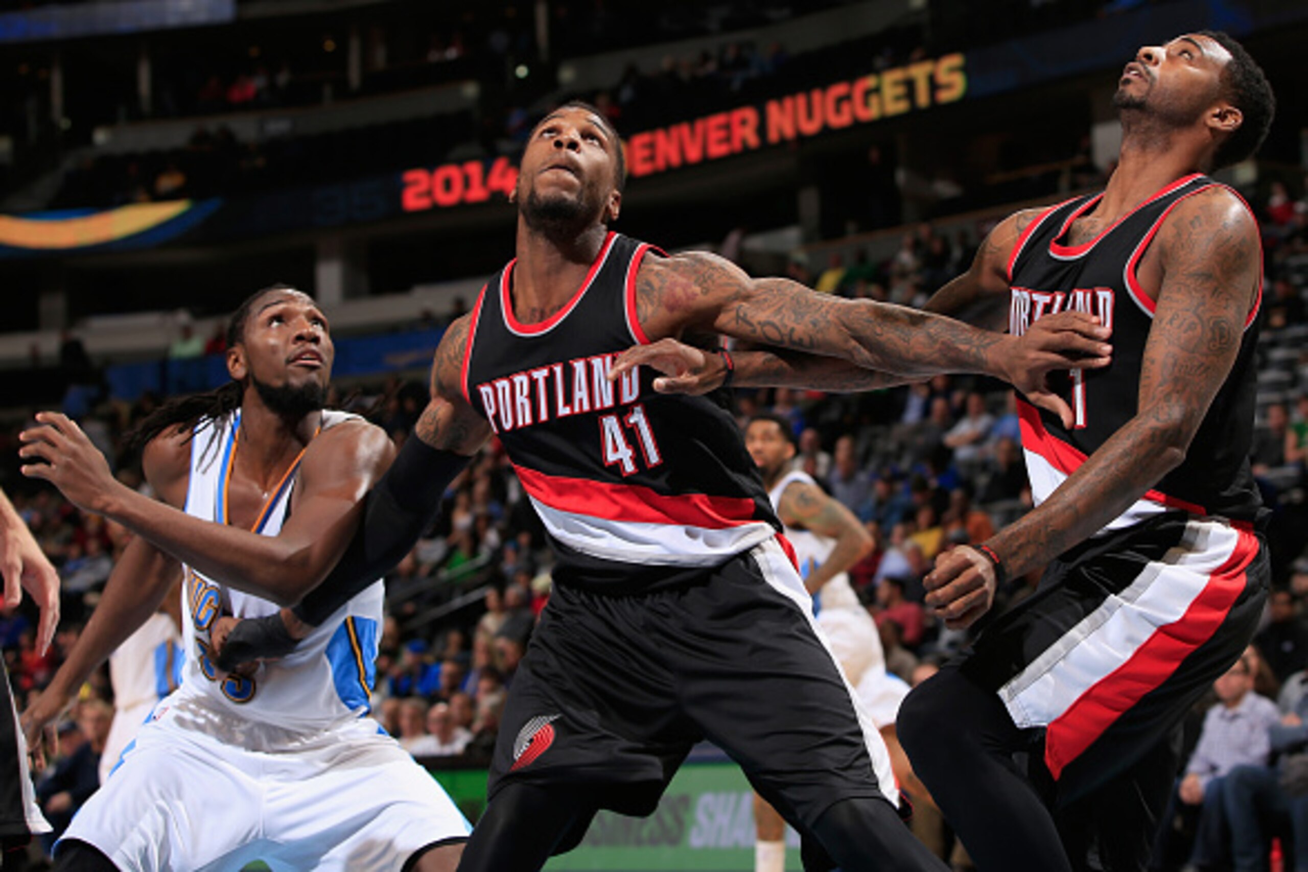 DENVER, CO - NOVEMBER 12:  Thomas Robinson #41 of the Portland Trail Blazers battles for rebound position with Kenneth Faried #35 of the Denver Nuggets and Dorell Wright #1 of the Portland Trail Blazers at Pepsi Center on November 12, 2014 in Denver, Colo
