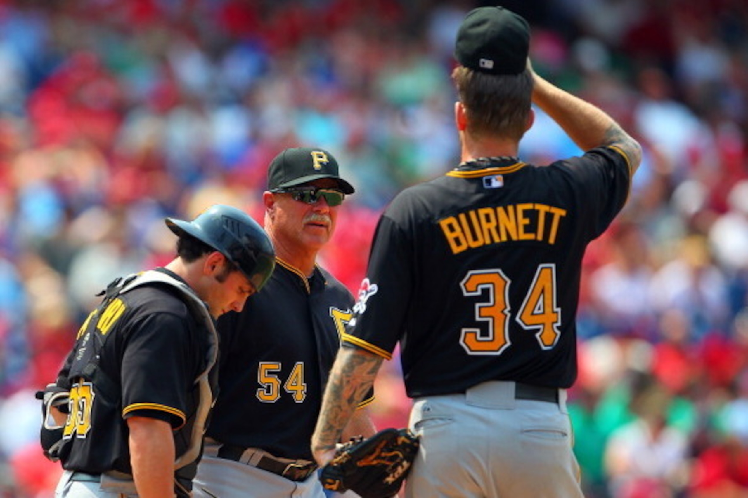 PHILADELPHIA, PA - JUNE 28:  Pitching coach Ray Searage #54 and catcher Michael McKenry #55 visits the mound to talk with starting pitcher A.J. Burnett #34 of the Pittsburgh Pirates during the seventh inning against the Philadelphia Phillies during a MLB 