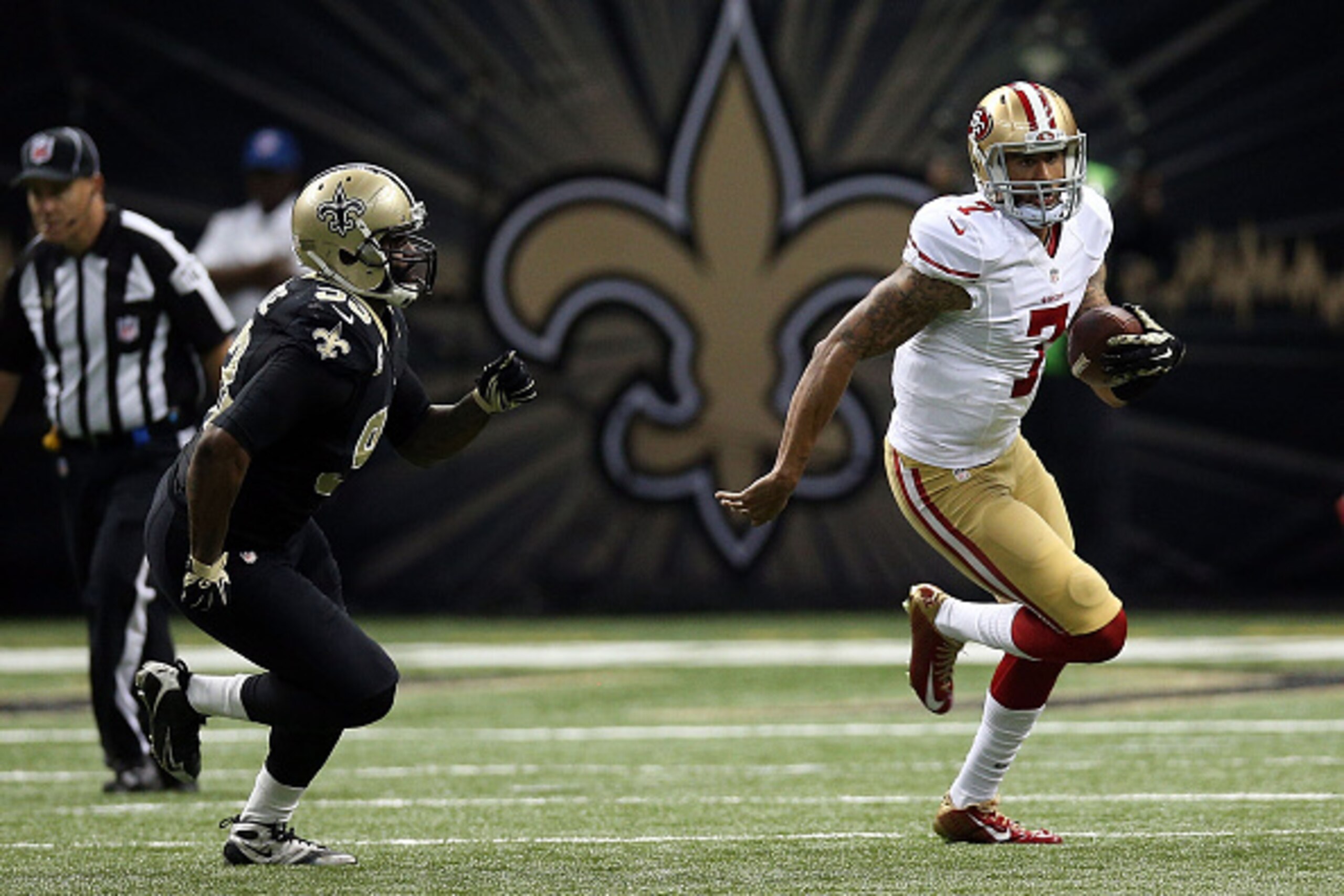 NEW ORLEANS, LA - NOVEMBER 09:  Colin Kaepernick #7 of the San Francisco 49ers is pursued by Junior Galette #93 of the New Orleans Saints during the second quarter of a game at the Mercedes-Benz Superdome on November 9, 2014 in New Orleans, Louisiana.  (P