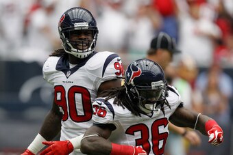 HOUSTON, TX - SEPTEMBER 07:  D.J. Swearinger #36 of the Houston Texans celebrates with Jadeveon Clowney #90 after sacking Robert Griffin III #10 of the Washington Redskins in the first quarter at Reliant Stadium on September 7, 2014 in Houston, Texas.  (P
