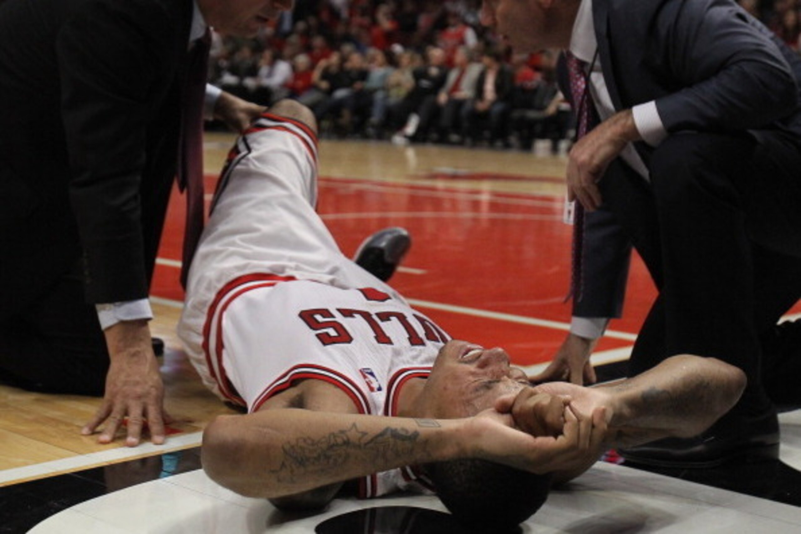 CHICAGO, IL - APRIL 28:  Derrick Rose #1 of the Chicago Bulls is examined after suffering an injury against the Philadelphia 76ers in Game One of the Eastern Conference Quarterfinals during the 2012 NBA Playoffs at the United Center on April 28, 2012 in C