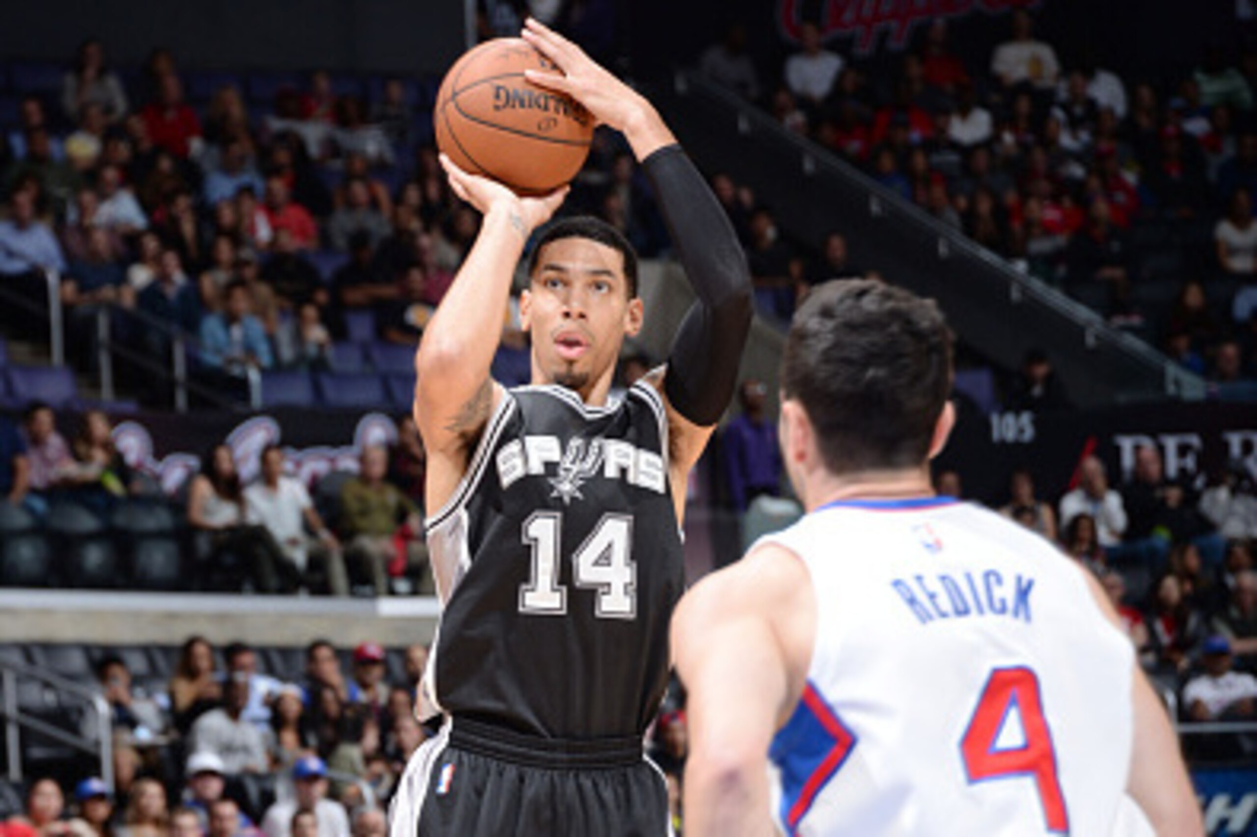 LOS ANGELES, CA - NOVEMBER 10: Danny Green #14 of the San Antonio Spurs shoots against J.J. Redick #4 of the Los Angeles Clippers during the game on November 10, 2014 at STAPLES CENTER in Los Angeles, California. NOTE TO USER: User expressly acknowledges 