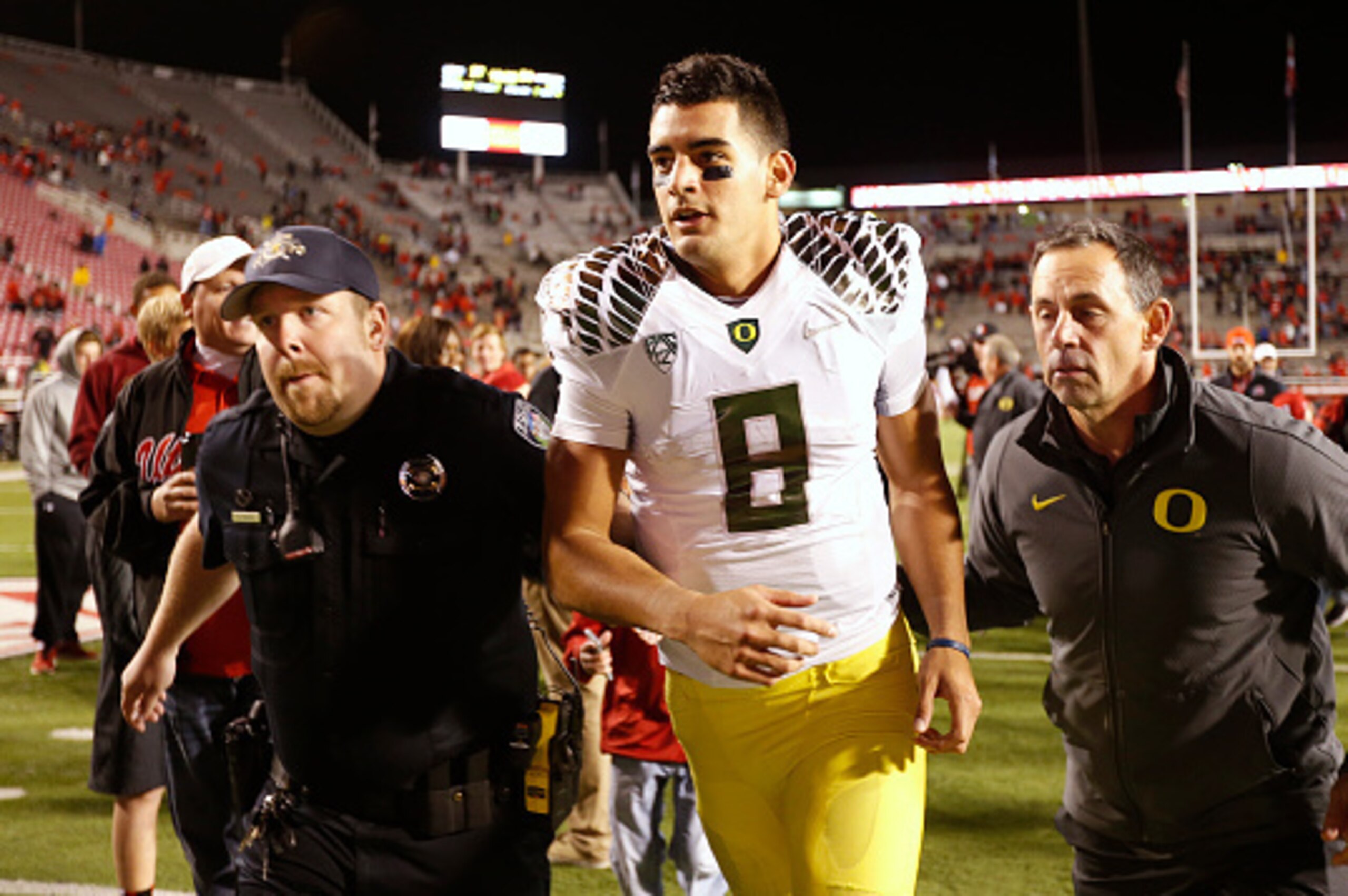 SALT LAKE CITY, UT - NOVEMBER 8:  Quarterback Marcus Mariota #8 of the Oregon Ducks is escorted off the field after a game against the Utah Utes at an NCAA football game November 8, 2014 at Rice-Eccles Stadium in Salt Lake City, Utah. Oregon defeated Utah