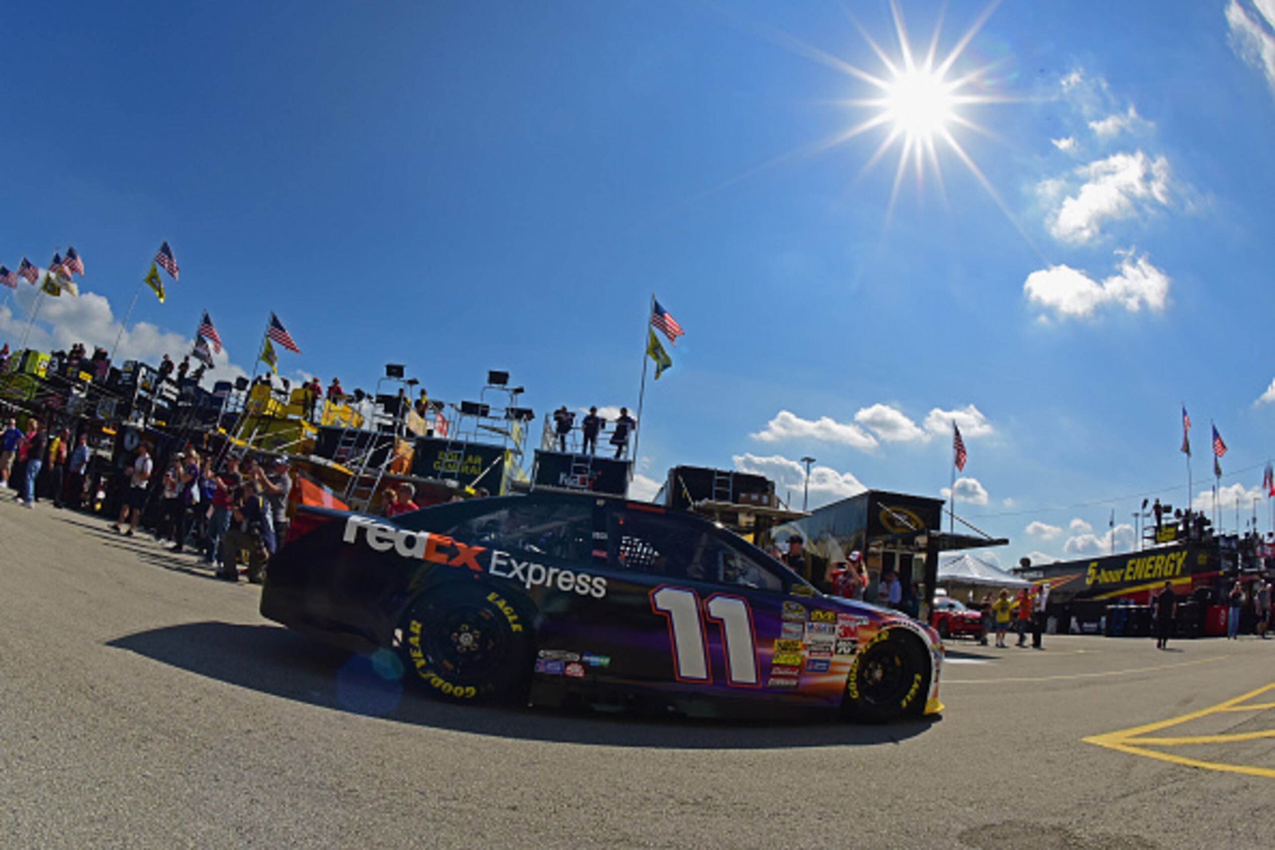 HOMESTEAD, FL - NOVEMBER 14:  Denny Hamlin, driver of the #11 FedEx Express Toyota, drives through the garage area during practice for the NASCAR Sprint Cup Series Ford EcoBoost 400 at Homestead-Miami Speedway on November 14, 2014 in Homestead, Florida.  