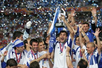 LISBON, PORTUGAL - JULY 4:  Traianos Dellas of Greece lifts the trophy during the UEFA Euro 2004 Final match between Portugal and Greece at the Luz Stadium on July 4, 2004 in Lisbon, Portugal. (Photo by Alex Livesey/Getty Images)