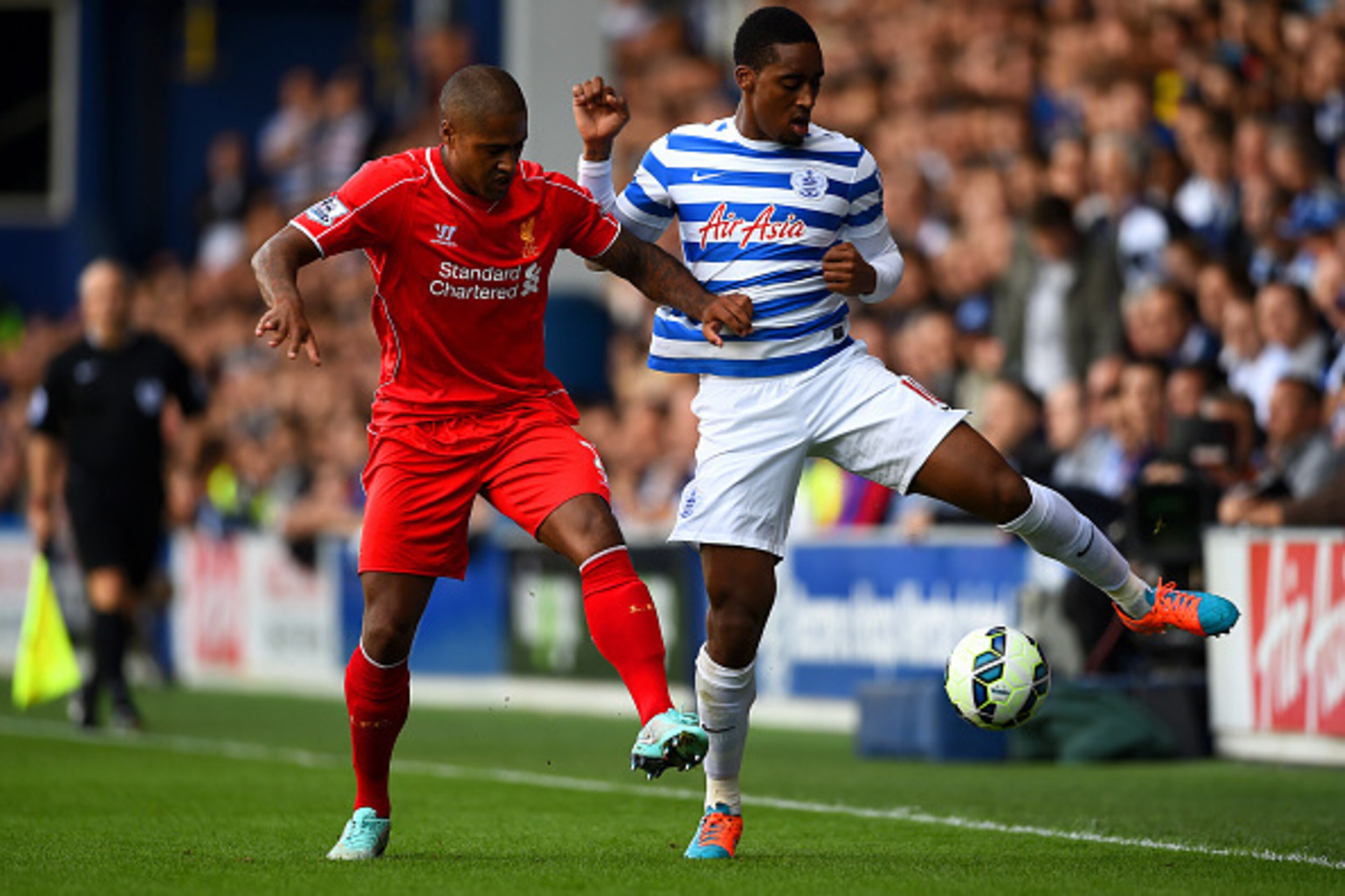 LONDON, ENGLAND - OCTOBER 19:  Leroy Fer of QPR battles for the ball with Glen Johnson of Liverpool during the Barclays Premier League match between Queens Park Rangers and Liverpool at Loftus Road on October 19, 2014 in London, England.  (Photo by Paul G